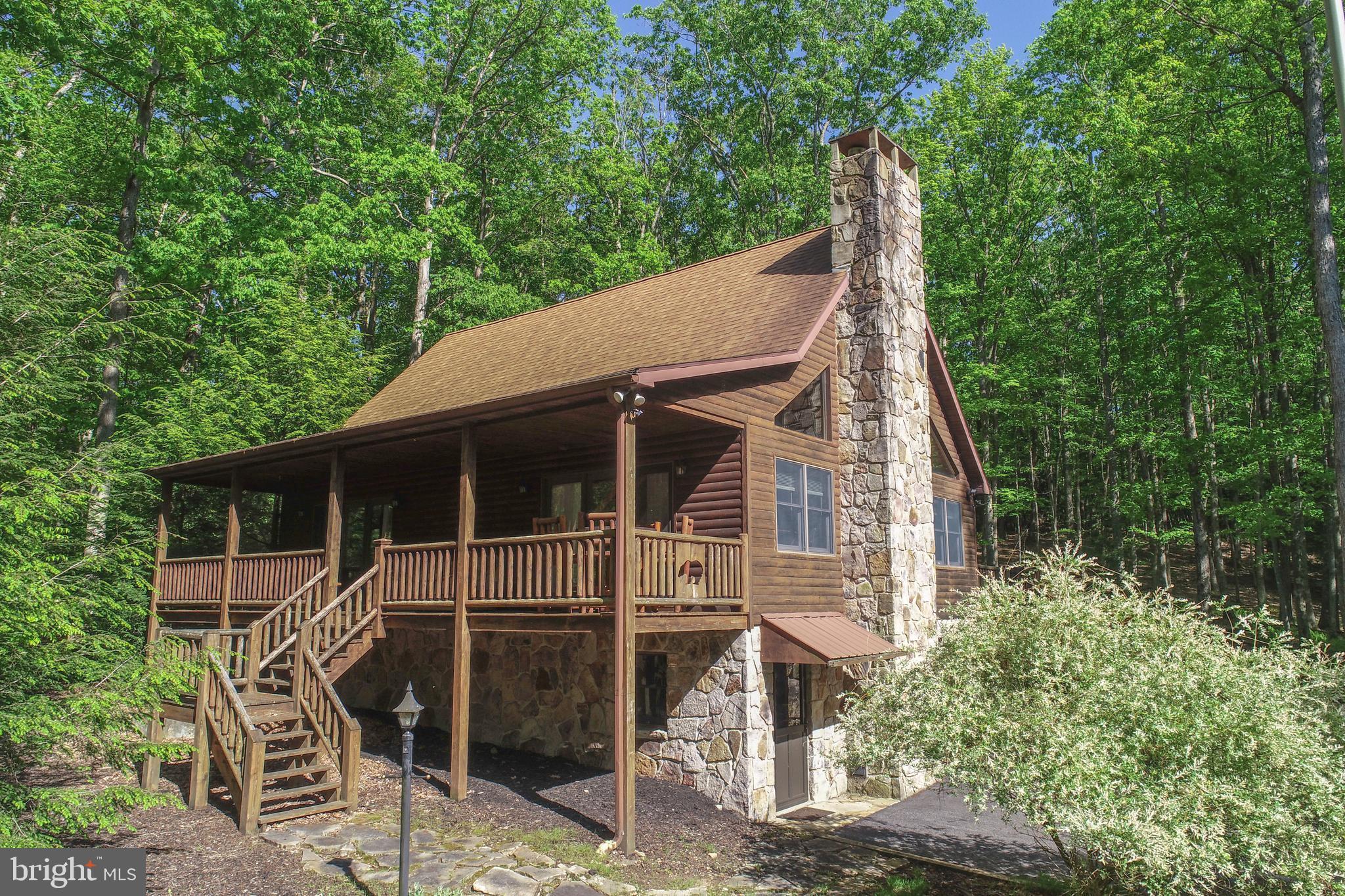 Escape to Serenity: Your Dream Log Home Awaits! Nestled in the heart of a picturesque lake and mountain area, this charming log home offers the perfect blend of rustic charm and modern touches. With cathedral wood ceilings and a cozy gas fireplace, the spacious living area invites you to relax and soak in the warmth and beauty of your surroundings. The living area steps out to a large covered porch and the kitchen area is off of a second large deck with a hot tub and an area for outside dining. The loft primary bedroom and bath are a wonderful retreat with a balcony for morning coffee with a space for an at home office. Spacious main level bedroom with two closets and a sliding door leading to the covered porch. A second main level bedroom and a full bath complete the picture. The lower level has a family room for movies and a cozy electric stove. Large utility room 2 closets. An attached one car garage is off of the utility room that could be easily finished. Located on a beautiful, large, private lot with a wonderful fire pit for smores and storytelling. A large barn style storage shed is also included. Close to all the activities that Deep Creek Lake and Wisp Ski Area have to offer! Whether you're looking for a year-around retreat or a vacation getaway, this property provides the peace and seclusion you've been dreaming of. There is a public access to Deep Creek Lake just down the street. Drop a kayak or go fishing! Call today for your exclusive viewing!