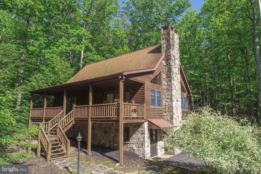 Escape to Serenity: Your Dream Log Home Awaits! Nestled in the heart of a picturesque lake and mountain area, this charming log home offers the perfect blend of rustic charm and modern touches. With cathedral wood ceilings and a cozy gas fireplace, the spacious living area invites you to relax and soak in the warmth and beauty of your surroundings.  The living area steps out to a large covered porch and the kitchen area is off of a second large deck with a hot tub and  an area for outside dining.  The loft primary bedroom and bath are a wonderful retreat with a balcony for morning coffee with a space for an at home office.  Spacious main level bedroom with two closets and a sliding door leading to the covered porch.  A second main level bedroom and a full bath complete the picture.  The lower level has a family room for movies and a cozy electric stove.  Large utility room  2 closets. An attached one car garage is off of the utility room that could be easily finished.  Located on a beautiful, large, private lot with a wonderful fire pit for smores and storytelling.  A large barn style storage shed is also included.  Close to all the activities that Deep Creek Lake and Wisp Ski Area have to offer!  Whether you're looking for a year-around retreat or a vacation getaway, this property provides the peace and seclusion you've been dreaming of.  There is a public access to Deep Creek Lake just down the street. Drop a kayak or go fishing! Call today for your exclusive viewing!