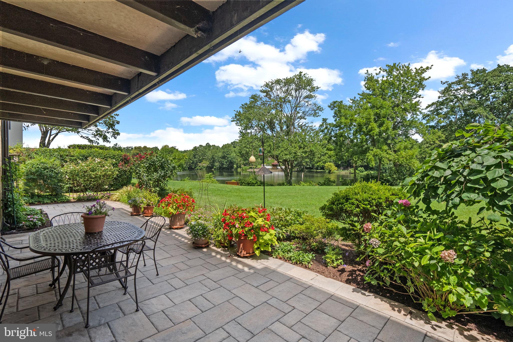 This beautifully updated 3 bedroom, 2 bath condo has breathtaking waterfront views of Wilde Lake! The expansive patio has lush gardens that you’re sure to enjoy while watching the seasons change over the lake from your own home. The hardscaping was newly upgraded, including durable concrete tiling. Whether you're enjoying morning coffee or evening sunsets, this space offers a peaceful escape right at home. The modern chef’s kitchen is a showstopper, featuring maple cabinetry, stunning granite countertops, an oversized island with seating, custom sink with prep station, and even a built-in ironing board for added convenience. The open-concept layout flows seamlessly into the dining and living areas, perfect for entertaining guests or enjoying quiet evenings. The primary suite has large windows giving you plenty of natural sunlight. With two closets, including a walk-in, there is plenty of space. The updated ensuite bath has a glass-enclosed custom tiled shower, quartzite countertops, and electric heated floors that you’ll truly appreciate in the cooler months. Two additional bedrooms and another updated full hall bath are just down the hall. A washer and dryer are conveniently located in the unit. Over $100K in upgrades including custom interior barn doors & pocket doors, porcelain tile flooring, updated electric panel, Ecobee programmable thermostat, wireless security system and more! Situated in The Cove, a highly sought-after neighborhood with a private pool, EV charging stations, and well-maintained grounds. A new roof is scheduled for 2025 and has already been paid for, and hot water is included in the monthly HOA fee. Just minutes from Columbia’s top attractions and miles of scenic trails. Welcome home!