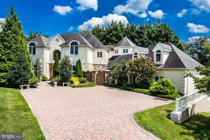 Welcome to this magnificent 5-bedroom, 3 full bath, and 3 half bath estate that exudes the charm and elegance of the French countryside. Nestled on a private lot, this home offers a harmonious blend of sophistication, comfort, and opulence. From the moment you set eyes on this home, you'll be captivated by the allure of this exceptional property.  The 3+ story rear atrium staircase is breathtaking and runs from the finished basement to the main living space, and finishes off with a vaulted ceiling on the upper floor.  There is also a luxuriously designed elevator that travels all 3 floors of this gorgeous custom home. As you enter the gracious 2 story foyer, prepare to be amazed how seemlessly the rooms flow between each other. The foyer is flanked by a formal living room and a large dining room perfectly suited for large dinner parties.  Adjacent the dining room is the gourmet kitchen with butlers pantry so all your serving needs are conveniently within reach.  Just outside the butlers pantry is patio area inspired by the French countryside that offers space for cozy gatherings.  The eating area of the kitchen provides ample light with large windows and French doors that open to a Juliet balcony. Just around the corner from the eating area is a corridor that leads to the oversized 3 car garage and a 6th bedroom or artist's loft.  For those in need of an In-Law or caregivers suite, this bedroom/loft space provides the possibility for versatility for various living arrangements.  In addition, the half bath adjoining this area has the opportunity to be converted to a full bath as necessary. Elegance is the defining feature of this residence, exemplified by the ornate medallion moldings above the chandelier lighting in each bedroom, adding a touch of regality to the space. The expansive bedrooms provide ample room for relaxation with several containing vaulted ceilings or ensuite baths. Descend to the basement retreat, a haven for leisure and entertainment. Equipped with a great room, pool table, and a wine cellar, it is the perfect spot to host gatherings and celebrations, making every occasion truly memorable while still offering ample storage. You don't have to worry about losing power because this home has a backup generator that runs the entire home as necessary. This luxurious property is a masterpiece of design, offering an enchanting escape from the hustle and bustle of everyday life. If you seek a home that seamlessly marries the allure of French country design with modern comforts and indulgences, look no further. Come and experience the timeless beauty and unmatched grandeur of this exquisite French country style colonial estate.