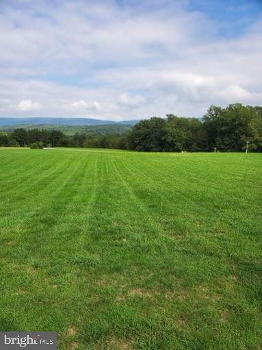 Stunning scenic and mountain views located in a quiet subdivision ready for you to add your dream home! Land has been completely cleared backing up to tree line and has a view of Sleepy Creek! Lot is just under 2.5 acres!
