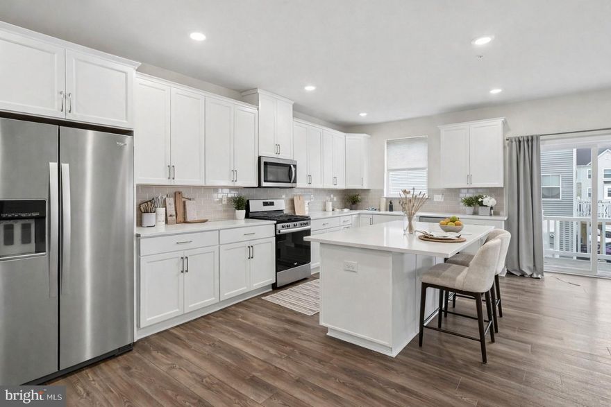 Move-in ready Cambridge Luxe townhome in the desirable River Pointe community! This thoughtfully designed 3-bedroom home offers 2 full baths and 3 half baths across four finished levels of stylish, flexible living space and a Rooftop Deck! The entry level features a 2-car garage and a spacious recreation room with a half bath, perfect for a home office, gym, media room, or playroom. The bright main level boasts 9-foot ceilings, oversized windows, and low-maintenance LVP flooring, along with a stunning kitchen complete with white 42” soft-close cabinetry, quartz countertops, a large island, stainless steel refrigerator, and a sleek 3x6 gloss tile backsplash, plus a dedicated dining area, expansive great room, and additional half bath ideal for entertaining. Upstairs, enjoy the convenience of a full laundry area with washer and dryer, a relaxing primary suite with walk-in closet and en-suite bath featuring dual sinks and a beautifully finished subway tile shower, and two additional bedrooms with a hall bath. The fourth-floor loft with powder room and private rooftop deck is the ultimate retreat for morning coffee or evening gatherings. This is the largest model in the community! Located in Bridgeport, just minutes from King of Prussia Mall, I-76, I-476, and Route 202, with easy access to King of Prussia, Conshohocken, and Philadelphia, River Pointe offers exceptional convenience near dining, nightlife, and outdoor recreation—schedule your tour today and move right in.