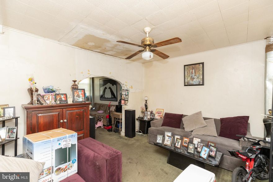 AFFORDABLE PORCH FRONT ROWHOME WITH LARGE ROOM SIZES!  Main level with living room, dining room, and kitchen, upper level with 3 bedrooms and 1 full bath, unfinished basement w/ half bath, and large fenced yard! Sold As-Is!  Seller will make no repairs.  Tenant occupied