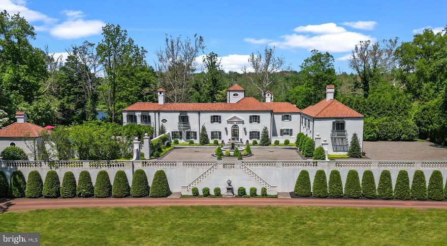 Nestled along the picturesque banks of the Delaware River, in the quaint town of New Hope, Pennsylvania, this remarkable 7-acre estate stands as a testament to unparalleled luxury and timeless elegance. Crafted by the visionary architect William Lawrence Bottomley, every facet of this property exudes a European charm that captivates the soul.

As you meander up the Belgium stone driveway, anticipation builds, leading to a grand courtyard adorned with a magnificent 3-tier fountain. The facade of the European-style villa commands attention, setting the stage for the opulence that lies within.

Step inside to discover a world of refined living spaces, where 5 bedrooms and 6 full bathrooms, along with 2 half baths, offer an oasis of comfort and sophistication. The meticulous attention to detail is evident at every turn, from the oak floors of the formal Dining Room, aglow with the warmth of a custom Venetian chandelier, to the expansive chef's kitchen, where culinary delights come to life amidst upgraded marble countertops and top-of-the-line appliances.

Beyond the kitchen, a glass conservatory beckons, offering panoramic views of the tranquil Delaware River. Here, mornings are greeted with sunlight dancing across the waters, and evenings invite quiet reflection as the sun dips below the horizon.

Entertainment knows no bounds in this estate, with a spacious living room adorned with 1920's parquet floors and a built-in wet bar, perfect for hosting gatherings large or small. Adjacent to the living room, a sunroom awaits, bathed in natural light streaming through nine sets of French doors that open onto the stone patio, where the heated pool, jacuzzi, and pergola create an outdoor haven for relaxation and enjoyment.

Ascending the grand staircase to the second floor, three generously appointed bedrooms await, each boasting its own ensuite bathroom. A handsome study with built-in Mahogany bookcases provides a quiet retreat for work or leisure, while the primary bedroom exudes luxury with its gas fireplace, Juliet balconies, and built-in speakers.

For guests seeking privacy, a bonus guest suite offers two spacious bedrooms with ensuite bathrooms and a private entrance, ensuring comfort and convenience for all who visit.

No expense was spared in the 2016 renovation, ensuring that this estate remains a paragon of luxury living. With easy access to New Hope, Lambertville, Philadelphia, and Princeton, this property offers the perfect blend of tranquility and accessibility—a rare gem awaiting its discerning owner.