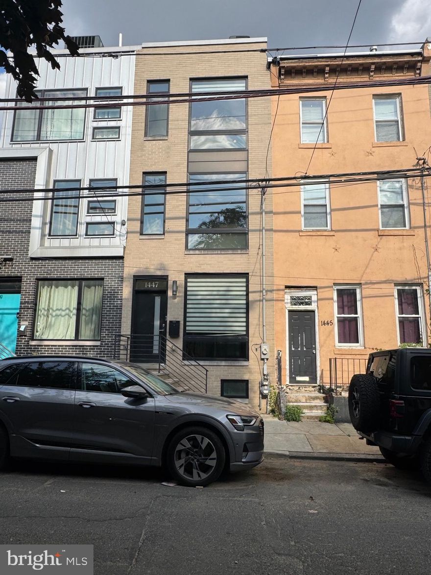 Welcome to the heart of Brewerytown! Located at 1447 N 28th Street, this spacious 4-bedroom, 3-bath townhome was built in 2017 and offers approximately 2,500 sq ft of modern living space. The open-concept main floor is filled with natural light and features a large  kitchen with quartz countertops, high-end appliances, and ample cabinet space. Just off the kitchen, step out to your private fenced-in patio, perfect for entertaining. Upstairs, you’ll find two generous bedrooms, a full bath, and a convenient laundry area. The third-floor primary suite includes a walk-in closet and a spa-like primary bathroom with walk-in shower and soaking tub. Enjoy stunning city views and sunsets from the private roof deck. The finished basement adds a fourth bedroom and full bath, offering flexible space for guests or a home office. Additional features include dual-zone HVAC and 2 years remaining on the tax abatement. Close to Center City, Fairmount Park, Kelly Drive, and walkable to popular shops, breweries, and restaurants. Schedule your showing today!