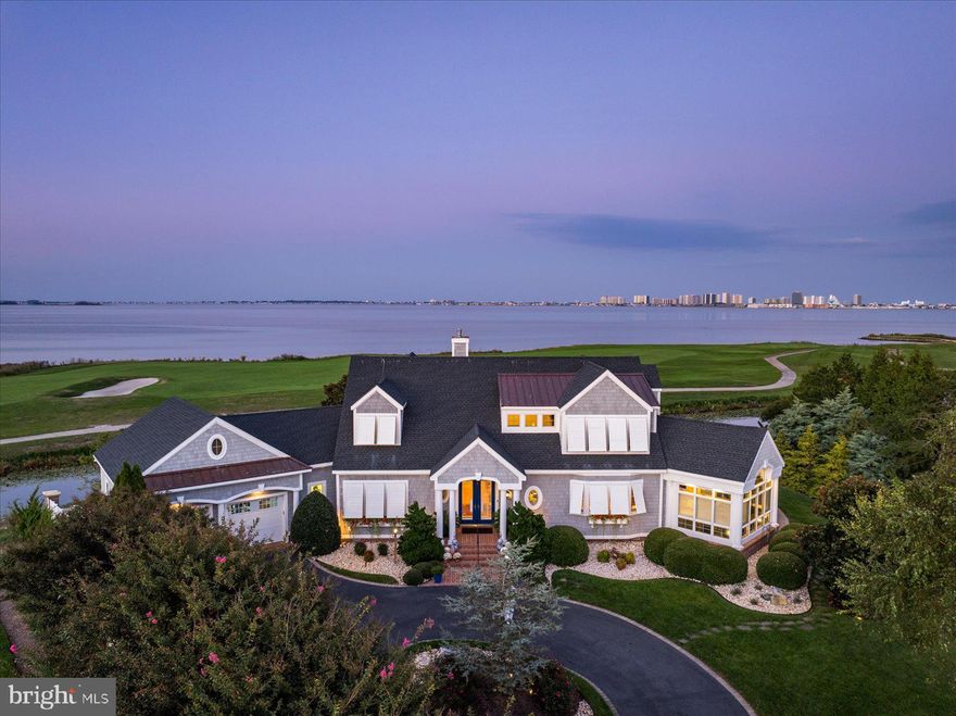 This impeccably maintained custom home was designed by the esteemed architect Ron Morgan of Becker Morgan Group in Salisbury, MD. One of the homeowners is a professional interior designer and her attention to detail is evident throughout the property. Constructed in 2000 by Bunting Construction, the home underwent significant updates in 2020, including new NUcedar shingle siding and a new roof with architectural shingles and standing seam solid copper accents. Situated in Lighthouse Sound with direct views of the Assawoman Bay and the Ocean City Skyline, this property offers a rare opportunity to own in a 1,000-acre golf course community, designed by Arthur Hills and featuring holes laid out along the tidal marshes of the bay, further enhancing the appeal of this home.   Special features include a primary first floor bedroom with dual walk-in California-designed closets and fireplace all overlooking the bay and pool/spa.   The bedroom offers direct access to the spa/pool.   VERY spacious primary bath complete with bay front garden tub, walk-in shower, and a water closet.  The large office directly across from the primary bedroom offers tall cathedral ceiling and window-shaped openings for additional light and airflow. Dramatic and sophisticated staircase railings are enjoyed in the great room and upstairs family room.   Speaking of the upstairs family room... be SURE to sit in one of the chairs there facing the bay and take in the awesome views from this perspective. MUCH more information on this prestigious property will be available at the open house! JOIN US for the premiere OPEN HOUSE on Sunday, October 20th, from Noon until 4:00, to discover more about this exceptional property.