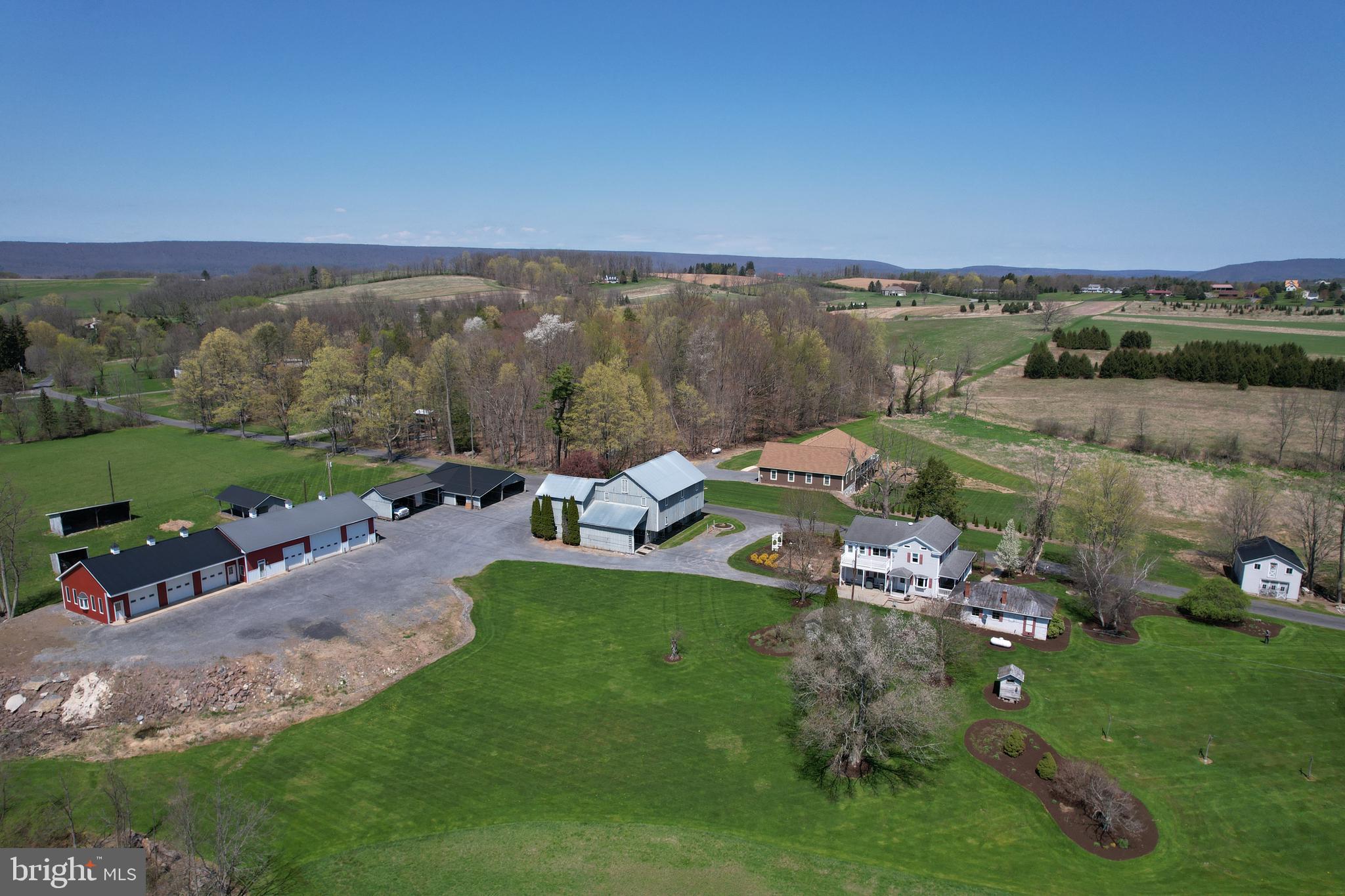 Versatile 33-Acre Property with Stream, Restored Barn, Modern Garage, and Updated Home.
This unique 33-acre property offers a rare combination of natural resources, well-maintained structures, and functional upgrades—ideal for personal use, small-scale farming, or business operations.
A trout-stocked stream runs through the property, which has been professionally landscaped by the owner, a former landscaper. The result is a park-like setting that feels like a private retreat, yet easy to maintain and highly usable.
The restored barn, dating back to the late 1800s, is in excellent condition and set up for five horses. It includes a newer metal roof, electricity, water, drains, a sawdust shed, hay drop, granary, and ample storage. There’s a fenced horse pasture with electric fencing, and the tillable land is used for hay and oats. Additional outbuildings provide extra space for storage or equipment.
For business or hobby use, a 20-foot tall, six-bay metal garage is fully insulated and features propane heat, electricity, water, interior drains, and is plumbed for a bathroom. It also includes an office, making it a great setup for someone looking to run a business from home or maintain a vehicle collection.
The house combines original charm with thoughtful updates. Built in 1910 with a later addition, it retains chestnut wood walls in both the original structure and the new section for a cohesive look. It offers three heating systems—two heat pumps and radiant heat in the basement—and a backup generator that also powers the barn.
There are four large bedrooms, including two primary suites—one on the main floor and another upstairs with a private sitting room, soaking tub, and balcony. The home is designed with ample storage throughout. This home also has an emergency generator that powers not only the whole house but the barn as well!
The seller also has plans for a 10-acre buildable lot, with a completed perc test. While the subdivision hasn’t been finalized, the plans are available for the buyer’s review.
This is a well-cared-for property with significant infrastructure already in place—ideal for a wide range of residential or business uses.
Main home is not located in a flood zone, but some parts of the property are.
Proposed 322 Connector project does not impact this property.