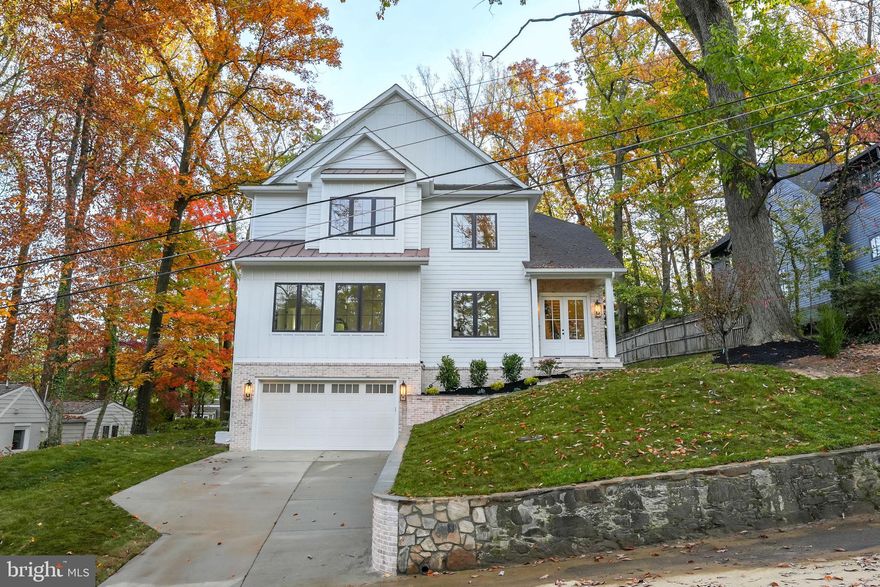 Experience Luxury Living at Its Finest! Welcome to a spectacular new construction nestled in the heart of Falls Church City. This stunning residence boasts nearly 7,000 square feet of exquisite living space on a beautiful lot exceeding a quarter of an acre. From the moment you step inside, you'll be captivated by the abundance of natural light streaming through the expansive windows, the soaring ceilings on all three levels, and the extraordinary open floor plan that exudes elegance and sophistication. A grand foyer with gorgeous checkered marble flooring leads to natural hardwood floors throughout. Every aspect of this home is generously proportioned, offering an unparalleled sense of space and comfort. The main level is an entertainer's dream. The gourmet kitchen, a true masterpiece, features a central island, an expansive walk-in pantry, and Sonos speakers that provide the perfect ambiance, with sound extending to the office, master bathroom, basement, and deck. Adjacent to the kitchen is a delightful sunroom sitting area, perfect for morning coffee or afternoon relaxation. The dining room, elegantly separate, provides an ideal setting for formal gatherings. The spacious family room, complete with a cozy gas fireplace, opens through French doors to the lush backyard, creating an effortless indoor-outdoor living experience. Additionally, the main level includes a bedroom with an ensuite full bath, a private office, and a large mudroom with lockers, a bench, built-ins, and a full-size washer and dryer, with dual access from the main level and lower level stairway.  The upper level is equally impressive, showcasing a luxurious and expansive primary suite. This serene retreat includes a cathedral ceiling, a mini bar, a sitting area, and a huge walk-in closet with island drawers. The spa-like full bath features double vanities, dual showers, and a soaking tub, perfect for unwinding. The additional bedrooms on this level are thoughtfully designed with ample space and convenience. Two bedrooms share a Jack and Jill bath, while the fourth bedroom enjoys its own full bath. This level also features a second laundry room equipped with a full-size washer and dryer for added convenience. The lower level is a sanctuary for entertainment and relaxation. It includes a meticulously designed recreation room with a large wet bar, a media room/fitness center, and a sixth bedroom with a full bath. The oversized two-car garage provides access to the lower level or direct entry into the main level mudroom. Conveniently located just minutes from Metro, I-66, and I-495, Falls Church City offers an array of restaurants, shops, and local events. This home is not just a place to live—it's a lifestyle. Don’t miss the opportunity to make this luxurious residence your own.