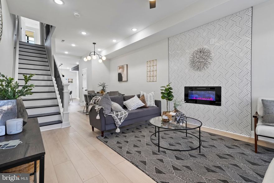 This House may qualify for Baltimore City vacant to Value $10k grant!! Step into your dream home! This house is meticulously crafted with 3-bedroom, 3.5-bath that spans over 1700 square feet across three levels. The journey begins as you enter the open and airy living area that seamlessly flows into the dining room and gourmet kitchen. This kitchen is a home cook delight, it's equipped with high-end appliances, a gas stove, built-in- microwave, granite countertops and an accent wall with plenty of room for dining in. Luxury vinyl floors and windows throughout brings in so much natural light which creates a warm and welcoming ambiance. The living room beckons cozy nights by the fireplace, while the adjacent dining area flows through the kitchen into the fenced in yard, perfect for outdoor grilling or entertaining. Venture to the second level, there are two junior suite bedrooms await with private ensuite bathrooms, along with a convenient hallway laundry hookup and ample closet spaces with a balcony. Boasting a fully finished basement, you'll find the 3rd bedroom and a large bathroom with walkin shower, in addition to a BONUS room-thats perfect for a home office/additional bedroom or home gym. This house is perfectly situated near John Hopkins Hospital, Downtown Inner Harbor, Camden Yard etc. and on public transit line. Do not miss the opportunity to make this exquisite property your own. Schedule your private showings today.