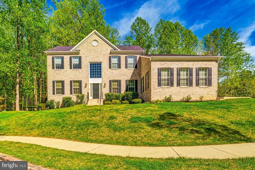 This stunning home boasts a classic brick exterior and a convenient 3-car side entry garage. Nestled on a tranquil cul-de-sac, it stands as the largest model in the community, ideal for lavish entertaining.

Upon entering, the grandeur of this residence is immediately evident. The two-story foyer floods the space with natural light, complementing the majestic center stairway. To either side, you'll find a formal living room and an office space, offering both elegance and functionality.

Step beneath the staircase bridge to discover the heart of the home: a sprawling two-story open family room, kitchen, and dining area. The expansive kitchen features an oversized island, perfect for cooking and mingling with guests. French doors beckon you to the private patio, surrounded by lush trees for serene outdoor dining.

Upstairs, the primary bedroom impresses with its spaciousness and tray ceiling, while the ensuite bathroom exudes luxury. Pamper yourself in the opulent bath, complete with a doorless walk-in shower boasting multiple heads, a luxurious soaking tub, and dual sinks.

The walkout basement serves as the ultimate retreat, offering a kitchenette, game room, theater, bedroom, and full bath. Whether hosting gatherings or enjoying quiet relaxation, this home caters to every need with style and sophistication.