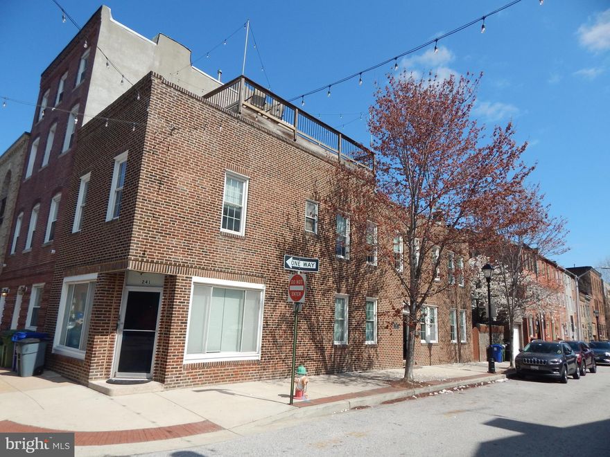 This stunning, HUGE, EOG rowhome is located in the heart of Little Italy and Harbor East. Fine dining and bakeries right out your front door.   LOCATION, LOCATION, LOCATION.  Walking distance to Harbor East, Inner Harbor & Fells Point.  This is City living, at its very best! This home has been meticulously renovated and cared for and boasts many original details, including wood floors and stained glass windows.  Currently, the home is set up as a 2-unit and AirBnBs each one for excellent income - 1 BR 1BA and 3BR 3BA unit.  This is what I would call a CASH COW! Can be easily converted back to a single -family home  or live in the 3BR home and rent out the 1st. fl. 1Br apartment.  Main house has huge kitchen with plenty of cabinet space.  Walk out to your outdoor courtyard with privacy fence and enjoy your morning coffee underneath your flowering dogwood tree.  A few more steps lead you to your own detached one-car garage. WOW this is huge because garages in this area are very rare.
This home has entertaining and enjoyment in abundance with a Large, rooftop Deck.  You can see the entire skyline from here and it is spectacular, especially at night.  Enjoy cocktails in the evening as you gaze upon the city lights.  Beautiful!  This home is a rare find and will not last long.  Once you visit, you will call it home!