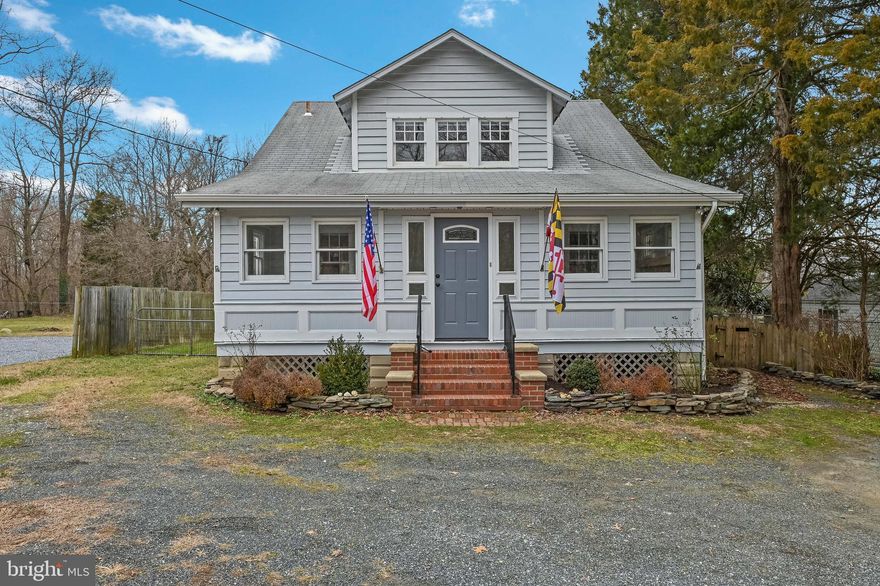 Charming cape cod!  This 4 bedroom, 2 bath home is surrounded by marinas, county parks and blue ribbon schools.  From the minute you pull up to the home and step inside you will be greeted with original details which makes this home feel special.  This home boasts original hardwood floors, fresh paint, new full bath upstairs, cozy porch with gas fireplace and loads of natural light,  Dutch door to the kitchen, breakfast nook and large fenced in lot.  You will find 2 bedrooms and 1 full bath on the main level along with living room, dining area and kitchen.  Off the kitchen is a large pantry as well as access to the deck and back yard.  On this spacious lot you will find a kennel space perfect for animal lovers or simply to be used as a place for storing your yard tools and water toys.  On the second floor you will find 2 bedrooms, large storage area and full bathroom.  Laundry and additional storage can be found in the basement.   Come take a look and make this your new home!