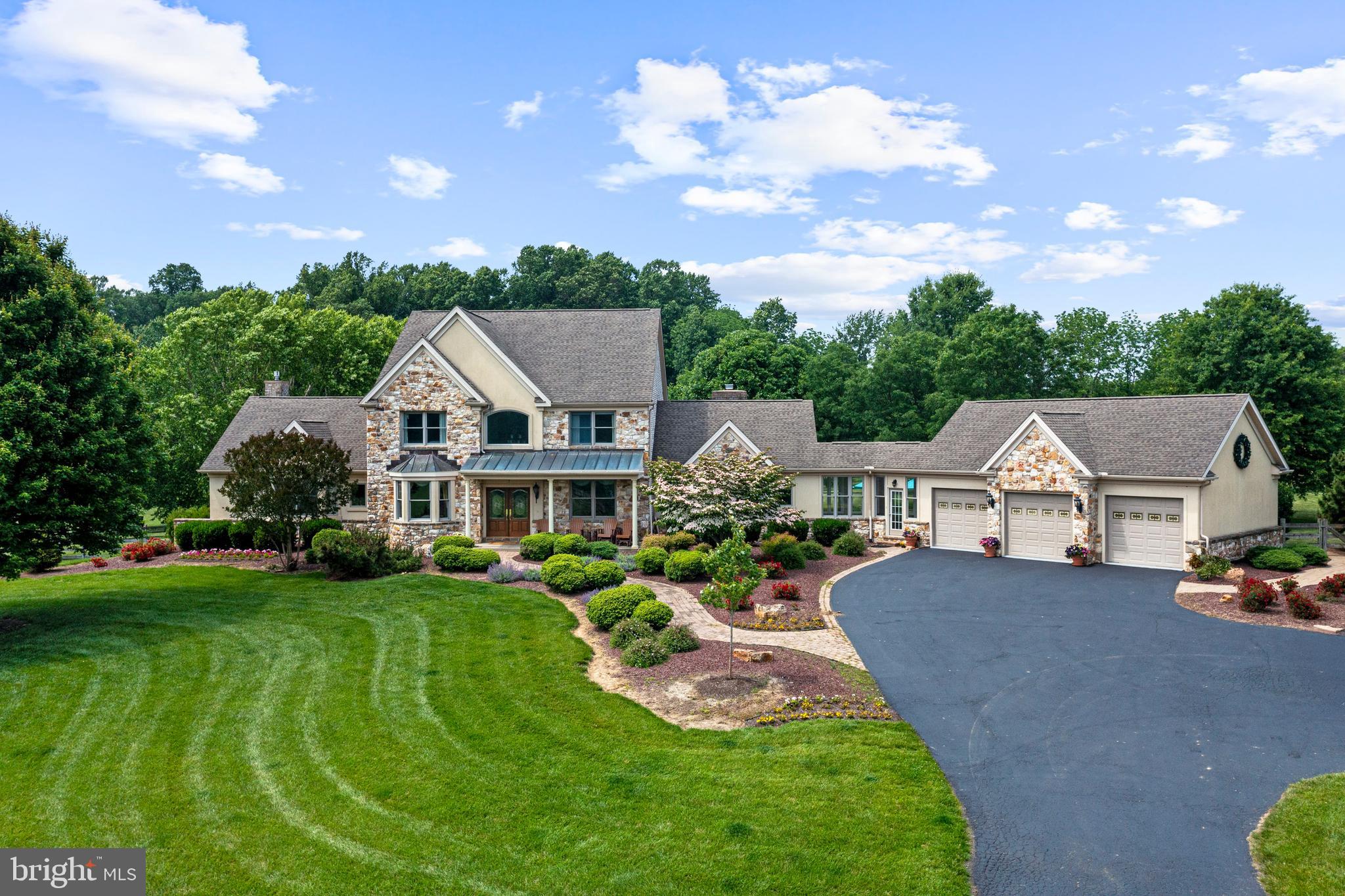 A Once-in-a-Lifetime Equestrian Estate Adjacent to Fair Hill Preserve .Welcome to an extraordinary opportunity to own a premier horse farm estate in the sought-after Avon Grove School District, set on 44.42 elevated secluded acres, bordered by protected lands and just 25 feet from the world-renowned Fair Hill State Park and Equestrian Center. This custom-built, 6,800 SqFt total living space area, stone and brick residence commands breathtaking panoramic views of sweeping fenced pastures, and is perfectly positioned for serious equestrians, with UPenn’s New Bolton Center just a short drive away. As you approach the property on a gently winding driveway, you’ll arrive at a stately custom home perched high above the landscape, offering privacy, grandeur, and unspoiled natural beauty. Inside, the main home showcases gleaming Brazilian hardwood floors, detailed mill-work, and expansive Anderson fenestration framing pastoral vistas. The gourmet eat-in kitchen features stainless steel appliances, level 5 granite counter tops, backsplash and opens to a sun-drenched family room with a wet bar, sun room, formal living and dining areas, and an executive home office. The main floor hosts one of two luxurious primary suites w/ adjacent professional office, ideal for multi-generational living or guest accommodations. The main level primary suite features dual walk-in closets, two-person spa Jacuzzi tub & walk in tiled shower with radiant heated floor complimented with a see-through gas fireplace set in imported marble. Upstairs, you'll find another oversized owner’s suite with spa bath, three additional bedrooms, and two full bathrooms—each designed with comfort and elegance in mind. A finished lower level offers even more living space with a huge recreation room, custom bar with full size refrigerator and seating, a pool room with additional tables and seating, an exercise room, another very `large bedroom, and full bath—ideal for guests, hobbies, or entertainment. Outdoors, equestrian excellence awaits. The professionally functionally designed barn includes six matted stalls, a tack room, and lockers with hot and cold water. Large paddocks, a 100 x 200 riding ring, and large grazing pastures have all been carefully maintained and are move-in ready for you and your horses. After a day riding, you’ll appreciate the thoughtful inclusion of a mudroom with a walk-in shower, located just off the oversized three-car garage. The southern exposure bathes the home in light and offers captivating views over Fair Hill’s 5,500-acre preserve, which includes miles of world-class riding trails accessible just twenty-five (25) feet away. Surrounded by other prestigious equestrian properties, this tightly knit and welcoming horse community is as rare as it is beautiful. Enjoy proximity to multiple international airports (PHL, ILG, EWR, JFK, LGA, BWI) with I-95 only 15 short minutes away. Access tax free shopping 3 miles away in Newark, DE with Christiana Mall less than a 20-minute drive. Fine dining abounds in local areas, Newark, Hockessin, Kennett Square, Unionville, West Chester, Longwood, Wilmington and Philadelphia along with many shopping options and services, all while living in a private, turnkey equestrian retreat. This is more than a home, it's a lifestyle.
