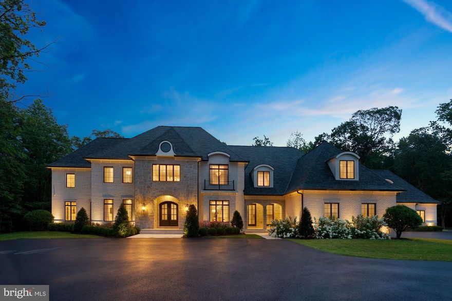 Prepare to fall in love with this one-of-a-kind home built by luxury home builder, Apex Custom Homes, which will exceed your expectations in every way. Behind the gates of the award-winning Creighton Farms Country Club community, this premium, private lot sits on 3.46 picturesque acres. The magnificent brick and stone, French-Transitional home features exquisite details and design elements including a six garage, porte-cochere, Travertine and wide-plank hardwood flooring, John Richard and custom chandeliers, high-end Quartzite, Marble and Quartz counters, five Sub-Zero refrigerators, four gas fireplaces, a temperature controlled glass wine-cellar holding 750 bottles of your finest wines, two main level Home Offices with glass French doors and one with built in shelving and Marble desk top, two Laundry Rooms, a Mud Room with built in cabinetry, central vac, 10’ ceilings on main and lower levels, and 9’ ceilings on upper level. The open floorplan in the heart of the home is an Entertainer’s dream with a Gourmet Kitchen perfectly suited for home chefs of every skill level that boasts superior design elements including a built-in Miele coffee machine, dual Miele dishwashers, beverage refrigerator, two full size refrigerators with freezers, Wolf six-burner range with a griddle, grill and double oven, 12 ft island and breakfast bar, Breakfast Room, and walk-in Pantry. The Kitchen seamlessly flows into the Living Room with a cozy gas fireplace and into the inviting Great Room with a soaring, chic coffered ceiling. The living space continues to the outdoors with access to the Travertine patio and covered pavilion with Quartzite counters, Marvel beverage refrigerator, Blaze built-in Grille and hood, masonry gas fireplace, and tongue and groove cathedral ceilings. Guests can access a full Bath directly from the outdoor living spaces and this backyard oasis has already been plumbed and wired for your future dream pool to be installed. The luxurious Owner’s Bedroom on the upper level boasts solid hardwood flooring, a gas fireplace, dual walk-in closets and dressing rooms, each with custom built-in wardrobes, cabinetry and dressers. The lavish En Suite Owner’s Bath has heated floors, dual vanities, a Spa-tub, and double entry walk-through spa-shower with steam and dual shower heads. Four additional Bedrooms on the upper level are each serviced by a private Bath, including the Princess Suite with Play Room and the Au-Pair Suite with Sitting Room and built-in beverage and computer center. Enjoy gatherings in the expansive lower-level entertaining space, which boasts a wet-bar complete with Wolf microwave, Sub-Zero ice-machine, two Sub-Zero beverage refrigerators, Miele dishwasher and a 15 ft Quartz counter bar. The Club Room opens up to the Rec Room and Game Room, which are separated by a dual sided gas fireplace. A Home Gym, state of the art Media Room, additional Game Room designed for younger adults, and a 6th Bedroom serviced by a full Bath are also located on the lower level. Additional outstanding features include an in-ground sprinkler system; wiring and prepping for a whole house generator including gas line and pad; water softener; dual hot water heaters; instant hot water in the Au-Pair Suite; four-zone HVAC system with UV light system; whole house humidifiers; dual sump pumps; interior/exterior surveillance cameras, built-in speakers throughout and professionally landscaped grounds. Creighton Farms is one of greater Washington DC’s most extraordinary, exclusive private club communities. The crown jewel at Creighton Farms is the 18-hole Jack Nicklaus championship golf course. Unparalleled resort style amenities include a state of the art golf facility with heated indoor bays, two Har-Tru & two USTA hard-surface tennis courts, fitness & wellness facilities, resort style pool and an elegant Club House offering indoor & al-fresco dining, overnight club rooms for members and guests, Board Room, Library, Golf Shop & more.