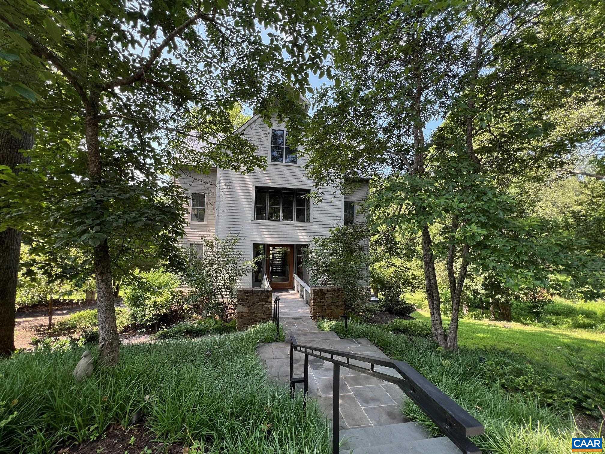 A breathtaking architectural masterpiece in Inglecress, offering nearly 5 acres of luxury, privacy, & natural beauty. Perfectly sited at the end of a peaceful cul-de-sac. Spectacular 4,432SF custom home showcases 4 bedrooms, 3 full and 2 half baths, & a dramatic modern design, fully reimagined by Alexander-Nicholson w/ the finest craftsmanship & materials. Step through a stunning mahogany pivot door into sun-drenched living spaces with soaring ceilings, sleek steel-and-oak staircases, and walls of glass framing endless pastoral and wooded views. The designer chef?s kitchen dazzles w/ Thermador appliances, marble waterfall counters, & custom cabinetry, flowing seamlessly into expansive living & dining areas w/ multiple fireplaces and a NanaWall opening to the elevated deck. Luxury primary suite is a true sanctuary w/ French doors overlooking Ivy Creek & a spa-worthy bathroom. The top floor offers a vaulted guest retreat, while the ground level features a chic family room, wet bar, and 2-car garage. Private elevator, whole-house generator. Relax on elevated deck, gather around the fire pit near the creek, or roam your own park-like grounds w/ direct trail access and 825ft of waterfront.,Marble Counter,Wood Cabinets,Fireplace in Family Room,Fireplace in Living Room