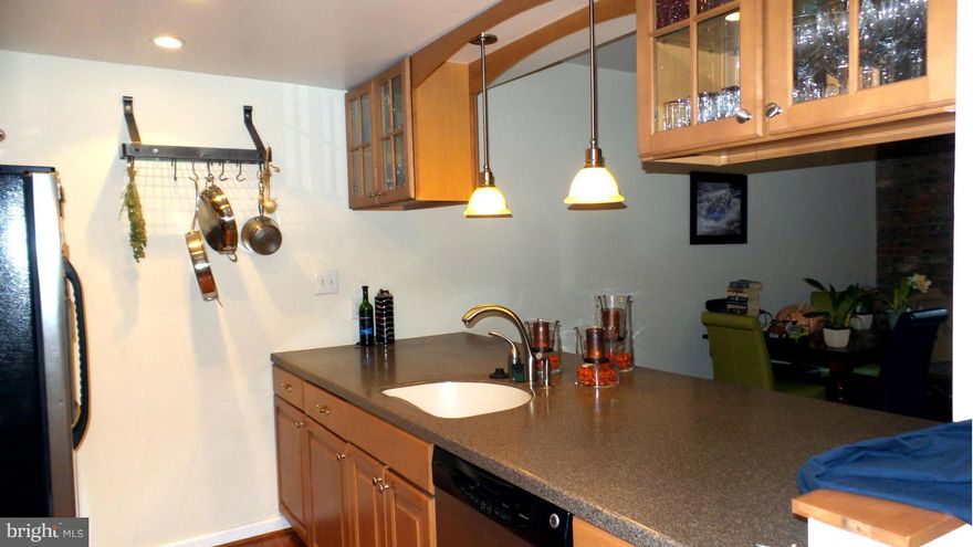 Charming one bedroom condo with exposed brick walls, updated kitchen and bath, hardwood floors and one garage parking space located in the quiet waterfront building of Henderson's Wharf. Prime location in Fells Point. Walk to restaurants and shopping.