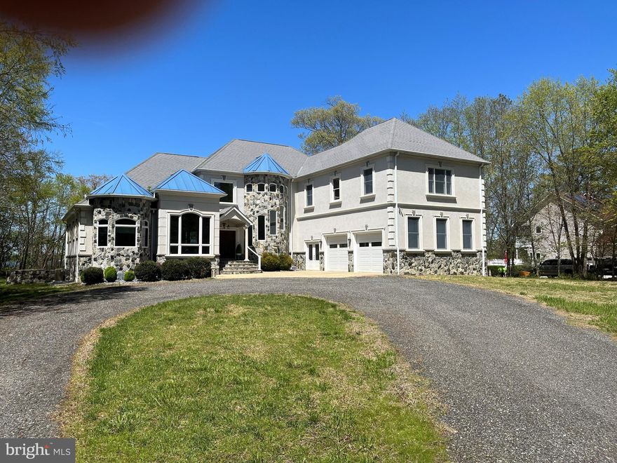 Stunning Custom-Built Waterfront Home situated on Breton Bay in Leonardtown. The views alone make this property a showstopper! There are so many attributes that make this home impressive, you will need to tour it in person to see the quality and craftsmanship throughout.  Main Floor Features: Welcoming wooden double doors greet you as you enter the splendidly spacious open floor plan; Striking 3” Tigerwood hardwood throughout mail level; Office space with chair railing and custom trey ceiling; Master suite, customized trey ceiling, 2 walk in closets with custom shelving and automatic lighting, lovely water view and door to patio; Master bathroom with double vanities, large stand up tile shower includes multiple shower heads, soaking tub with air dryer, tile floor; 2nd bathroom with custom sink and shower includes separate  door leading out to patio; Living room with water view, stone gas fireplace, beautifully handcrafted custom built ceiling and entertainment center; Dining room with water view, chair railing and custom trey ceiling; Gourmet Kitchen with water view, slate tile, upgraded countertops, built in microwave, abundance of custom cabinetry, gas stove with warmer for chef’s delight, large center island, cabinets all around, sitting area/table space; Huge mud room with slate floors; Laundry room, with laundry shoot from 2nd floor, slate tile, cabinet for storage, wash sink, extra-long counter for folding; 2-story foyer with wainscoting; Fully screened in back porch with slate tile. 2nd Floor Features: Wooden curved staircase, with custom handrail, Tigerwood floor in hallway; 2nd level master suite, 2 closets with custom shelving, huge sitting area, and separate desk area over garage; 3rd bedroom with water view and  door to outside deck with 14x6 closet with custom shelving; 4th bedroom with water view and sitting area, French door to outside deck, custom 14x6 closet; Bathroom with tile, 2 vanities, jetted tub, standing shower and extra storage. Basement Floor Features: Extra-large fully outfitted bathroom, with a tub/shower and sink; Bar area with sink and outlets for appliances; Full theater room with screen; Large area for gaming tables; 5th Bedroom with sitting area; Office space or room for home schooling, 5x11 custom closet with shelving; Plenty of storage for all your needs; Double exit doors to lead outside on both sides of home.  Throughout the home there is 1x7 custom baseboard door trim,  Anderson doors and windows. A whole house sound system for your enjoyment.  Oversized attached 2 car garage, double door entrance, with generator, and ample storage space. Additional detached 2 car garage with finished office space/loft above.  Stone and concrete circular driveway provide ample parking.  Screened-in porch and patio area provide a wonderful and relaxing entertaining area.  All your need to do is sit back with a cold beverage and enjoy your very own waterfront oasis! Estimated 120ft rip rap on shoreline.  To make this truly waterfront living, it includes approximately160 ft of pier, the perfect spot for sunning, crabbing, fishing, and boating.  The possibilities are endless!!