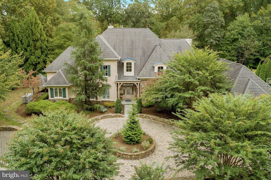 * Under Contract & accepting Back up offers*Breathtaking Lake View home that was custom built on 2.5 acres of sweeping grounds that can be seen from every window from this beautiful French Colonial home that is located 100 yards from L'Auberge Chez Francois.  A custom stone circular driveway welcomes you to this 5 bedroom 5.5 bath home with a grande vaulted foyer and two story living room with views of the lake and a beautiful stone gas fireplace. Main level includes a large formal dining room, expansive eat-in kitchen with a vaulted ceiling, sub-zero fridge, 6 burner cook-top, large island, coffee bar and open to the family room with four walls of windows and a large wood burning stacked stone fireplace. Located on the opposite wing of the house is the main level master bedroom with tray ceiling, large 6 piece bathroom, walk-in closet, and french doors that open to the sweeping grounds and lake views. Also located on the main level is an office with gas fireplace and built-ins, laundry room, mudroom and access to the three car garage. The second floor has a second master suite, loft hangout space,  two secondary bedrooms and a shared bath. Lower level is all about entertainment with a large theater room that is attached to a full stocked kitchen with two wine coolers, wrap around bar, built-in coffee maker and a wine tasting room and lounge. Also located in the lower level is a 5th bedroom suite with separate entrance, plus a large workout room, game room, second office and large storage room.   Outdoor entertaining is made easy with two patios, built-in gas grill, and stone fire pit all overlooking the  lake. Manicured grounds also include a two bay horse stable, basketball court, kids jungle gym and all within  a short walk or ride to your neighborhood French Bistro. Included in the sale is a whole house gas generator and electric fence.