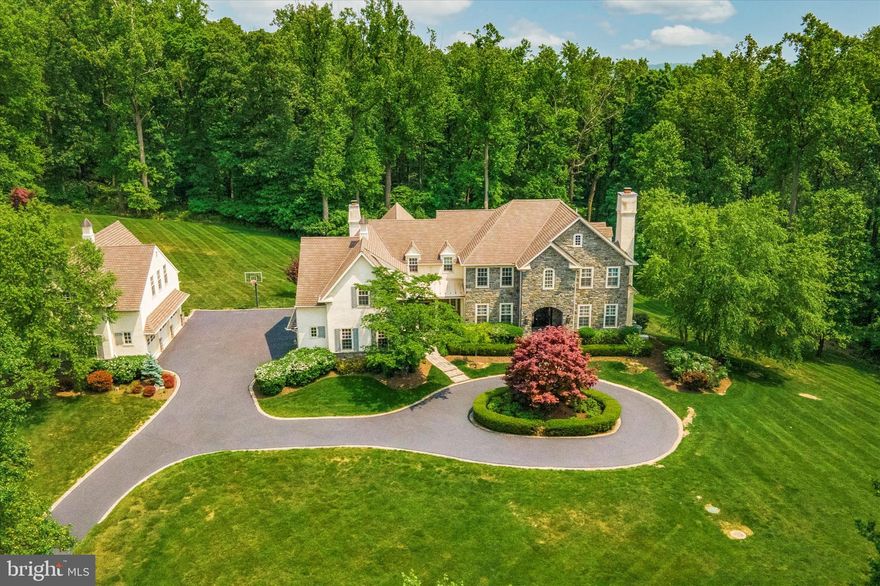 Nestled high in the hills of Malvern on over 6 acres of pristine grounds sits this immaculate 5-bedroom, 9,500 sq ft custom built estate. Welcome home to 2270 Old Sentinel Trail, just one of five homes in this private enclave surrounded by the Diamond Rock Preserve. The absolute epitome of tranquil, peaceful living for those who want to escape the commotion of everyday life. The best part? You get the best of both worlds with easy access to local amenities such as major highways, public transit, shopping and restaurants. Not to mention, downtown Malvern is less than a 15-minute drive and Phoenixville’s Bridge St is only 12 mins away. This home is located in top ranked T-E School District. From the moment you pull up the private drive you will be impressed with the french country estate feel and all the luscious landscaping surrounding the home. For those who have a large car collection will really appreciate the six-car garage (3 bays attached, 3 bays detached with unfinished space upstairs). No stone went unturned when it came to the design, layout and upgrades added to the property since it was built in 2007. The two biggest updates were the kitchen remodel in 2015 and enclosing the screened-in porch into the ultimate sunroom (added an extra 529 sq ft of living space). Step inside the stately front entry which showcases just the start of the beautiful woodwork found throughout the home. To the right is the formal living room, a half bath, large storage closet and the stunning corner study with breathtaking views overlooking the grounds. To the left of the formal entry sits the dining room. A set of glass doors lead to the storage pantry, impressive butler’s pantry, and opens to the incredible kitchen. It not only looks like a work of art (those reclaimed wood beams and live-edge island countertop are dream worthy), but it is also super functional and ready to take on even the largest dinner party. Stainless steel appliances, granite counters, hardwood flooring and two large islands complete the space. Enjoy a quick mid-week meal from the cozy breakfast nook that adjoins the kitchen. The family room includes a stone floor-to-ceiling, wood-burning fireplace (gas hookup available), a reclaimed wood mantle that matches the kitchen beams and two skylights that flood the room with natural light. Step down into the enclosed sunroom where your jaw will hit the floor after taking in the impressive views. Just imagine how beautiful this room will be on a snowy winter night! Finishing up the main level is a second half bath, mudroom entry to the driveway and a built-in desk to keep loose mail and everyday essentials at an easy reach. After a tiring day, retreat to the dreamy primary suite. A spa-like en suite includes a clawfoot soaking tub, two separate vanities and a walk-in shower. There are two separate walk-in closets and a private sitting room to enjoy your favorite tv show in peace. There are four remaining bedroom suites (two of the bedrooms share a full bath, while the others each have their own private baths), and a laundry room. Is a finished basement a must? Check it off the list! This space was built for entertaining! A large bar with a sink, ice maker and mini fridge sits next to the pool table and shuffleboard and side entrance to the backyard. An impressive wine room is sure to hold even the biggest wine aficionado’s collection and provides a good conversation piece while sitting at the bar. A movie theater area sits 8 guests, and additional seating could be added. There is a conveniently placed bathroom on this level, excellent storage space and room to create a home gym. High end stereo system provides music in most rooms. Not only are the views incredible from inside, but you will also enjoy them on the gorgeous flagstone patio complete with a removable fire pit and plenty of seating. With gorgeous views, impressive layout and incredible finishes, this retreat is one you won’t want to miss!