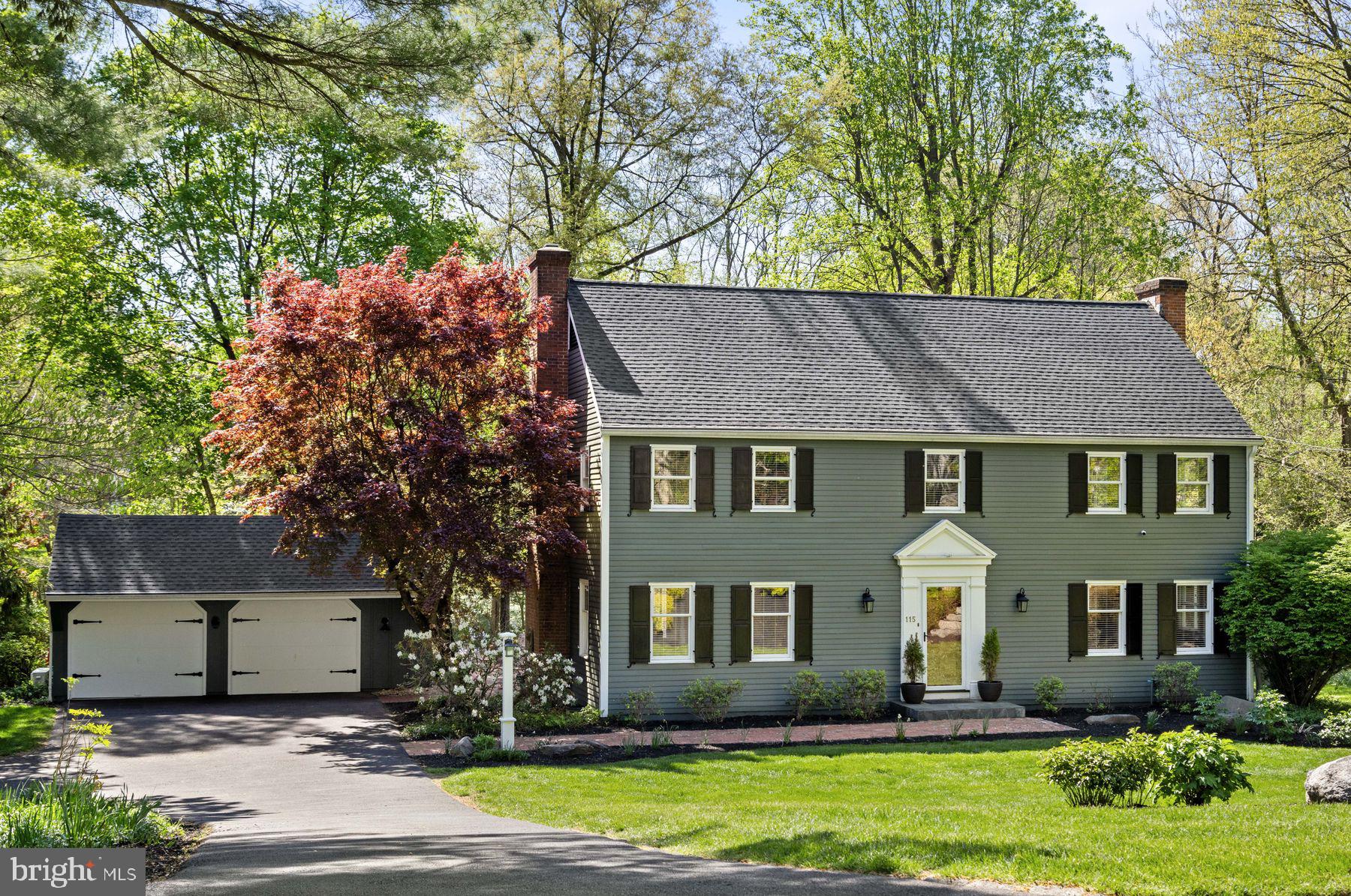 Perfectly sited among towering pines, flowering dogwoods, and mature maples, and surrounded by leafy gardens bursting with peonies, this stately cedar-sided Colonial offers a park-like setting in the desirable Foxcroft neighborhood, just minutes from Doylestown Borough. Classic in style yet fresh in feel, the wide brick path leads you into a welcoming foyer and a surprisingly open, modern floor plan designed for today’s lifestyle. Sophisticated details include picture frame molding, rich hardwood and ceramic tile floors, and contemporary lighting throughout. The living room features a wood-burning fireplace and built-ins, while double French doors open to a stunning 1,000+ SF brick courtyard with views of a stone wall-rimmed pond, lush landscaping, and a storybook footbridge. The kitchen is a chef’s dream with honed granite counters, full-height marble tile backsplash, large island with breakfast bar, soft-close cabinetry, 5-burner Viking propane cooktop, double wall ovens, Bosch dishwasher, and smart French door refrigerator. The adjoining breakfast nook with shiplap walls flows into a beamed family room with whitewashed brick fireplace and propane stove. A sunroom with vaulted ceiling and walls of glass invites relaxation and garden views. sliding barn door opens to the gym or flex room—perfect for workouts, an artist’s studio, or homeschool space—with inspiring pond views. A mudroom, laundry area, and powder room complete the main level. Upstairs, the primary suite boasts a spa-like bath with slipper tub, glass shower, and dual vanities. A dressing room/nursery adjoins, with two additional bedrooms, a hall bath with marble vanity and glass shower, and a cedar walk-in closet down the hall. The detached, heated and cooled 2-car garage offers an additional surprise—your own private man-cave, she-shed, or creative studio. This light-filled, refined home is nestled on a quiet, dead-end street surrounded by other elegant homes—minutes from dining, shopping, and the vibrant cultural life of Doylestown.