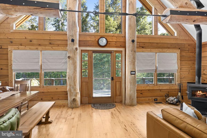 Discover the epitome of luxury living in this breathtaking custom Craftsman home, meticulously updated with an array of bespoke features that redefine modern comfort and elegance. Nestled on eight pristine acres with established walking trails and located within a serene subdivision—free from HOA restrictions—this property offers a unique blend of tranquility and sophistication.

As you step through the vaulted entrance you will notice an antique cast iron bell, the resonating sound will welcome family and guests as they arrive.  Upon entering you will be greeted by soaring beam ceilings, custom wood trim, and stunning shiplap walls that exude warmth and character. The open floor plan seamlessly connects the spacious great room, adorned with a cozy gas fireplace and a charming freestanding wood stove, to the expansive kitchen and dining area. The ambiance is elevated by all-new custom lighting, creating an inviting atmosphere perfect for both entertaining and relaxation.

The heart of the home—a beautifully updated kitchen—features brand new appliances and ample counter space, making it a culinary dream. The first-floor primary suite is a sanctuary of comfort, complete with it's own private bath & large walk-in closet. Upstairs, another primary bedroom with an en-suite bath awaits, complemented by a cozy loft that overlooks the grand great room.

Venture to the lower level, where a separate entrance opens into a versatile space—ideal for guests, an in-law suite, or even a short-term rental. This area includes an additional bedroom, a full bath, an office, and a generous storage area.

Outside, indulge in the custom TimberTech deck with unique railings, perfect for soaking in the serene surroundings. The property boasts an enormous 40’ x 50’ detached workshop, featuring oversized doors, an office area, and a car lift, catering to hobbyists and entrepreneurs alike. A 15’ x 35’ lean-to is perfect for a woodworking shop or additional storage needs. 

With a new metal roof, updated HVAC system, and meticulously refinished exterior, this home is not only stunning but also practical. Located just moments from Lake Anna, where you can enjoy sun-soaked days on the water, this property is a rare find.

Don’t miss your chance to own this one-of-a-kind Craftsman retreat, complete with exclusive features that will leave you in awe. Schedule your private tour today and let this stunning home welcome you to a life of luxury and serenity! 

Here is more detailed information on the renovations: HVAC system replaced, new metal roof installed and outside re-stained and sealed in 2022. New Gutters, Tankless Hot Water Heater, and kitchen appliances added in 2023. New carpet just installed in the main floor bedroom October 2025. VA assumable loan!