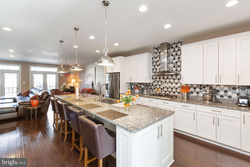 Immaculate & gorgeous 3 bed, 3.5 bath townhome featuring modern contemporary design w/ an open floor plan in sought-after Suburban Greene.  There is an entry level Full bath and sitting area with huge coat closet. 2nd floor features expansive living room boasts a sleek gas fireplace, a bright and inviting dining room is perfect for entertaining. The amazing gourmet kitchen hosts a large center island/breakfast bar, granite counters, brand new engineered hardwood floors through out, tankless water heater, brand new stainless steel appliances, modern tile backsplash, custom pendants & chandeliers by Tiffany's(tm) , ample soft-close cabinets with a powder room. The primary bedroom features two walk in closets, tray ceilings. There are two ample sized bedrooms and two additional full baths. The laundry is conveniently located on the bedroom level. Qualified buyers can receive up to $25,000 thru MMP program toward the purchase of this home. Ask Hans or Amanda for more info & schedule your showing today! *** HAPPY HOUR OPEN HOUSE SATURDAY 3/26 4PM-6PM***