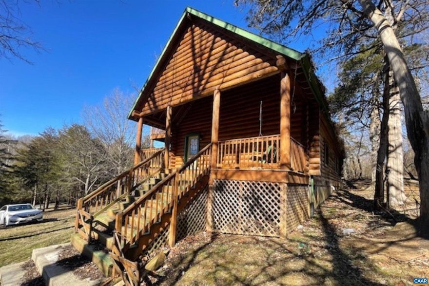 RARE FIND in the Fort Defiance school district! Escape to leisurely seclusion of your very own log cabin in the countryside of Augusta County.  Nestled on just over 4.5 acres, sits a quaint log cabin complete with large deck to enjoy the outdoors. Home features spacious, open main level with eye catching stone hearth in the living room, open kitchen/dining space and half bathroom. The upstairs loft is where you?ll find the primary bedroom with full bath, and space for a cozy sitting area and access to full deck with mountain views. This property also includes additional structures on the grounds, including a small cottage perfect for an office/studio and a larger shed for storage. Secluded and distinct, this private retreat in the countryside is a delightful place to call your own.,Fireplace in Living Room