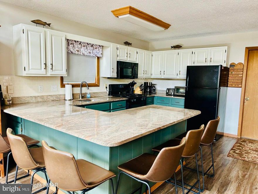 This beautiful 4-bedroom, 2- bath raised ranch sits on a desirable corner lot and includes a game  room /bonus room downstairs for added entertainment!! Enjoy a newly updated kitchen and a cozy fireplace in the game room, perfect for entertaining. This two-story home features decks on both levels, providing a great space to relax and take in the serene surroundings all while enjoying the wildlife in your own backyard! 

 Located in a amenity filled community with a restaurant and bar overlooking the lake and pool!! Tennis and basketball court, boat rentals, clubhouse,  plus golf carts are allowed as well! Monthly activities for families! Sit on the deck and enjoy a drink and LIVE MUSIC!!  Don't miss out on the spectacular home!!