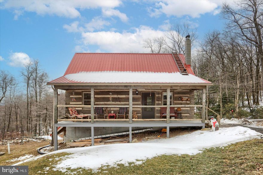 This exceptional, one-of-a-kind property offers unparalleled privacy and beauty! Nestled on 4+ acres atop Blue Mountain in Berks County, Pennsylvania, this FULLY OFF-GRID  home, built in 2011, provides the perfect retreat. The main floor features a spacious living room, dining room, kitchen, laundry area, and a cozy bedroom. The second floor boasts a primary bedroom, bath, and a charming loft. 120 year old wood flooring throughout! Every window and the expansive deck offer breathtaking, panoramic views of the surrounding landscape. The full walk-out basement adds even more space and potential. Every detail of the home and its exterior has been meticulously customized by the sellers to preserve the property's authenticity and charm. In addition to beautiful gardens and outbuildings, there is a quaint, original cottage built around 1961, situated across a serene back stream. This property is also an ideal opportunity for rental income, as it lies just 300 yards from the Appalachian Trail, making it perfect for hikers. Key features of the home include 2x6 framing, fully insulated walls, and a durable metal roof with 12 inches of insulation. The 10KW solar battery system powers the home, with 120AC and 12-volt DC lighting throughout. The water system includes fiberglass holding tank, softener, Ph, alkalinity treatment, UV lamp and additional reverse osmosis station. The well pump operates on 12DC for maximum battery efficiency. The 120,000 BTU  On-demand hot water heater is Lp fueled as is the full size kitchen refrigerator. 
NO MORE ELECTRIC BILLS!! This property is an outdoor enthusiast's dream, with a National Park to the west, State Game Lands to the north, and the Appalachian Trail just a short walk away. Experience the peace and serenity of this extraordinary, self-sustaining property—perfect for hikers, hunters, or anyone seeking an idyllic mountain retreat!