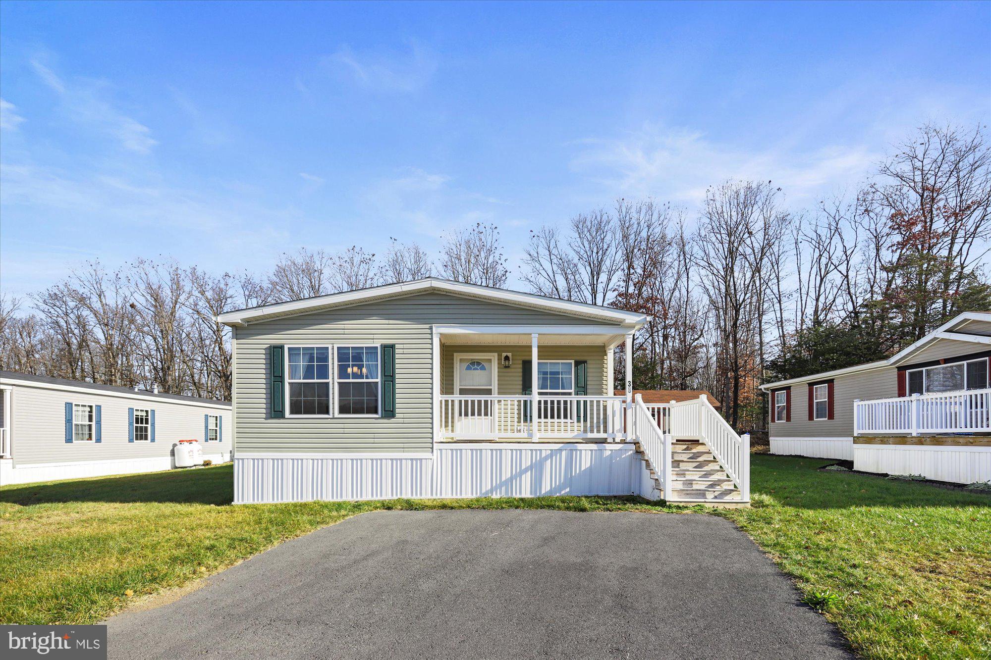 Welcome to the tranquil country setting of Country View Village! This home is only 1 year old and is in perfect move-in ready condition! It boasts an open floor plan with a spacious family room that opens into the kitchen. Cook all your gourmet meals in the large kitchen, which boasts a gas range, sizeable island and plenty of cabinetry for storage. The kitchen opens to the dining area and is perfect for all your meals and entertaining. You will pass a separate laundry room and hall bathroom on the way to the 3 nicely sized bedrooms. The generous primary bedroom features TWO walk-in closets! The primary bathroom is spacious and has a large soaking tub. The welcoming front deck is the ideal place to enjoy your morning coffee. The home backs to a nice tree line, great for deer watching! This home is a joy to own!