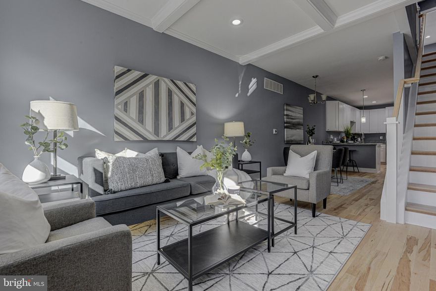 Gorgeous 3BR/3.5BA + Den rowhome renovation including deck, parking and CHAP tax credit (pending final approval). This property has been totally renovated including all mechanicals and will be sold with a 1 year builder's warranty. Enter into the open concept LR to new recessed lights, flooring, and coffered ceilings. the spacious LR leads to the DR space and kitchen. The brand new kitchen includes new cabinetry, stainless steel appliances (built-in microwave not in photos but will be installed), granite tops and a peninsula for 2 seats. Bonus half bath at the rear on the main level as well as access to the private rear parking. Upstairs contains the master suite which includes the bright front bedroom with an ample closet and a new custom-tiled standing shower and dual-vanity. There is a second BR and BA level 2 with the BR offering access to the rear deck. The 8-ft. newly water-proofed basement contains the third full bath as well as a third BR space and den. It also includes all of the new utilities and laundry room for a stackable washer/dryer. This incredible renovation won't last long - come have a look!