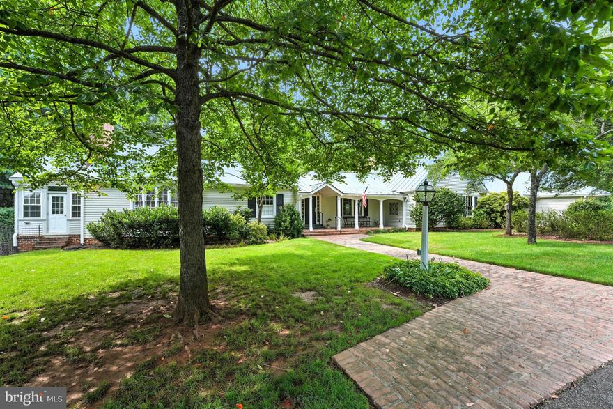 Welcome to Turkey Ridge … An Incredible One-of-a-Kind Property … Nestled on a sprawling 12+ acre waterfront estate lot, this exquisite one-level residence offers an unparalleled blend of luxury and tranquility, perfectly situated overlooking the serene shores of Lake Pelham. With breathtaking panoramic views of the lake, Old Rag and lush landscaping, this property is a true sanctuary for those seeking an exclusive lifestyle. Step inside to discover a meticulously designed interior that exudes elegance and comfort. The expansive 3,397 square feet of living space features rich hardwood and slate flooring, complemented by luxurious vinyl plank and ceramic tile accents. The heart of the home is a gourmet kitchen, equipped with stainless steel appliances, a spacious island, and granite countertops, making it a culinary haven for entertaining guests, furthered by the oversized formal dining room with fireplace. The adjoining family room, adorned with exposed beams and a massive custom stone fireplace, is complete with picturesque lake and mountain views. The residence boasts three generously sized bedrooms, including a primary suite with incredible views, sitting area, direct terrace access, a lavish walk-in closet/dressing room, two bathrooms and a dual-entry walk-in shower. Each bathroom in the home is thoughtfully designed with modern fixtures and finishes, ensuring a touch of sophistication throughout. Additional highlights include built-ins, recessed lighting, a wet bar, plantation shutters throughout and a 4-season room with radiant heat and AC, offering yet another comforting space to take in the water and mountain views, enhancing the home's functionality and style. Outside, the property is a masterpiece of landscaping, featuring extensive natural stone hardscaping, a wrap-around patio, charming gardens and complementary outbuildings. The meticulously maintained grounds offer a perfect blend of open space and wooded areas, providing both privacy and natural beauty. With 685 feet of waterfront access, indulge in a variety of water activities, from fishing to kayaking, all from your own private oasis. The attached garage accommodates two vehicles, while the circular driveway provides ample parking for guests. Enjoy the tranquility of lakeside living while being just moments away from local amenities, restaurants and recreational opportunities. This exceptional property is a rare find, offering a harmonious blend of luxury, nature, and comfort. Experience the ultimate in refined living-where every detail has been thoughtfully curated to create a home that is as inviting as it is impressive. Don't miss your chance to own this slice of iconic Culpeper paradise.