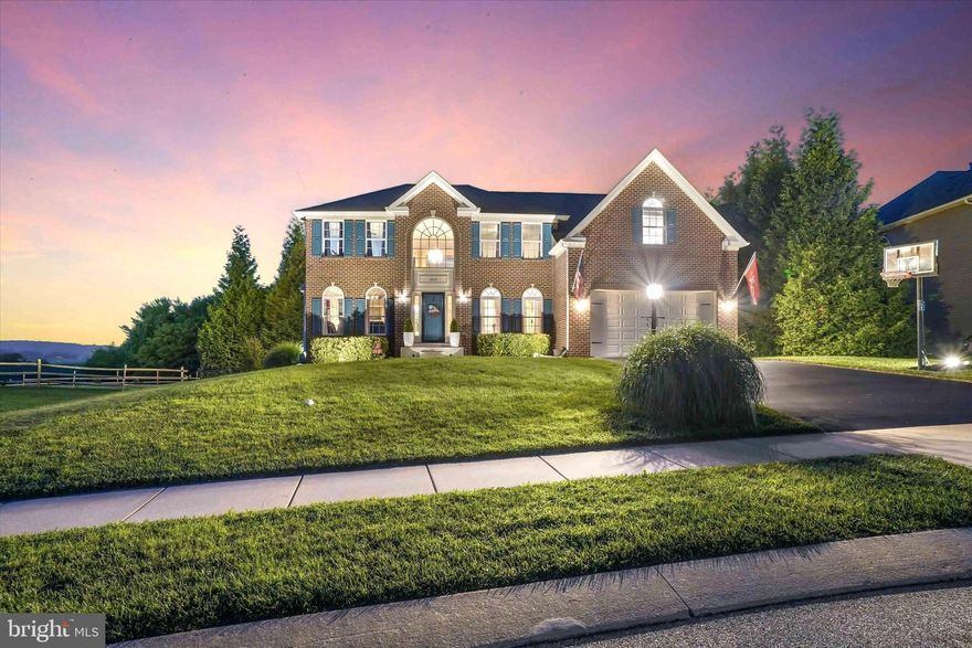 Gorgeous custom-built luxurious home with almost 5,000 sq ft of finished living space.  This home stands among the top tier in the neighborhood and is set on what could be considered the most coveted premium lot in the entire community. Nestled in the beautiful Codorus Estates neighborhood within the Southern York County School District. Surrounded by picturesque farmland and just minutes from the popular Codorus State Park—where you can enjoy hiking, boating, swimming, camping, and a wealth of outdoor activities—this location offers both tranquility and convenience, with shopping and dining nearby. This home beautifully blends the charm of country living with a modern, contemporary flair. Designed with an open-concept floor plan, it's truly an entertainer’s dream. Take in the pristine, meticulously maintained landscaping that surrounds the property, every view is both breathtaking and calming. Imagine starting your Saturday morning with a cup of coffee in hand, the gentle sounds of birdsong in the background, and a front-row seat to the natural beauty and serenity this home provides. As the day winds down, take in the breathtaking beauty of a sunset that paints the valley in warm hues of gold, rose, and lavender. Whether you're enjoying the view from the deck or through the expansive windows, each evening offers a front-row seat to nature’s masterpiece—an ever-changing canvas that brings peace and wonder to your everyday life. Inside, the beauty continues. Brimming with high-end upgrades, this home impresses with exquisite features and meticulous attention to detail at every turn. This impressive home features a thoughtfully designed floor plan that caters to modern lifestyles. Step into a bright, open foyer framed by a formal dining room and a formal front living space. Just off the foyer and adjacent to the great room, you'll find a beautifully designed home office featuring a charming bump-out that provides additional space and flexibility. Whether you're working remotely, managing daily tasks, or seeking a quiet retreat, this thoughtfully placed room offers the perfect blend of function and comfort—bathed in natural light and seamlessly integrated into the heart of the home, the great room and kitchen. The expansive main living area showcases an open-concept design that seamlessly connects each space for effortless flow and everyday living. Soaring cathedral ceilings elevate the space, while the sleek, open staircase adds a striking architectural element, seamlessly connecting the main level to the upper living area. The stunning floor to ceiling stone fireplace adds the perfect amount of ambiance for any occasion. Whether you're entertaining guests, or simply enjoying a quiet morning, this showstopping great room offers the perfect blend of elegance, comfort, and contemporary design. The gourmet kitchen features updated countertops, built in double ovens, a huge L-shaped center island with pull out shelves and lovely cabinetry on both sides along with a walk-in pantry. Whether you’re a culinary enthusiast or enjoy casual dining, this space is sure to inspire your inner chef. Nestled between the gourmet kitchen and the great room; a light-filled sunroom retreat bathed in natural light from expansive windows including bright skylights, this versatile space offers the ideal setting for morning breakfasts with a view. With seamless access to the rear yard and patio, indoor-outdoor living is made effortless. Upstairs, four spacious bedrooms and two full bathrooms. The primary ensuite features a luxurious bath and impressive custom walk-in closets. The finished walk-out lower level is a standout feature, providing an impressive 1,200 sq. ft. of living space. It includes a third full bathroom, a stunning floor-to-ceiling stone fireplace, and a bonus room currently used as a home gym—though it could easily serve as a playroom or additional bedroom. This is more than just a home, it’s an elevated lifestyle.