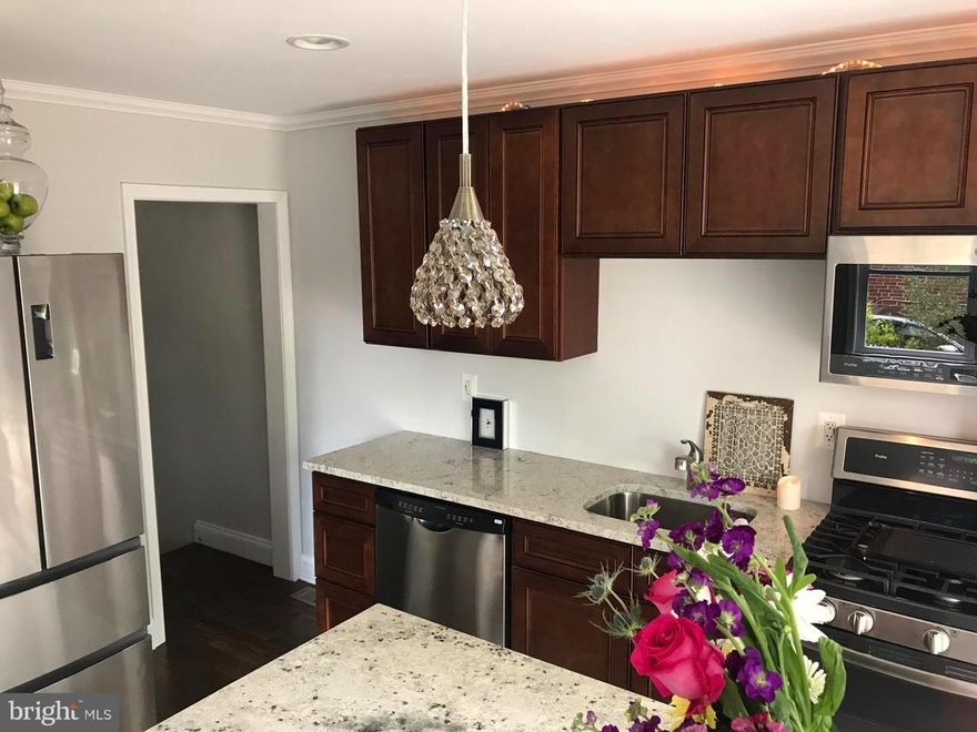 MUST SEE renovation...duplex with private driveway, huge deck for entertaining, security system, hardwood floors, family room, 3 bedrooms, 1 1/2 baths, all wood kitchen cabinets with gorgeous pantry, granite, breakfast bar, disposal, top of the line stainless steel appliances, including double oven; crown molding, new HVAC and CLOSE TO BUS STOPS! Ground rent to be verified by buyer.