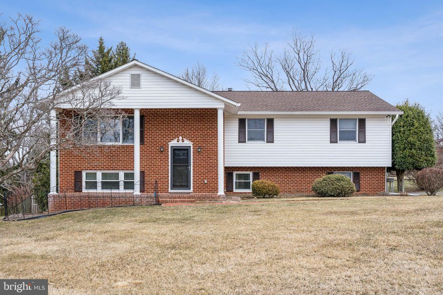 Impressive with its columned front porch, this Mount Hebron home offers an open floor plan with lots of natural light, updated kitchen and full baths, wood floors on the main level, and neutral tones that make it move-in ready. Located in the middle of this popular neighborhood, it is close to the high school, daily shopping,  commuter routes, and walking trails in Patapsco State Park. The open living -dining room includes large windows, and the kitchen has recent stainless steel appliances. The primary  bedroom has its own bath with a rainhead shower while the other bedrooms share a similarly updated hall bath with combination tub/shower and another rainhead shower. Downstairs, the family room has full sized windows and sliders that open onto the brick-edged patio. The utility room with washer, dryer, and utility sink, and the over-sized rear-entry garage are on this level. Recessed lighting is everywhere, and an existing power connection can be adapted for an electric car charger. More storage is in the shed in the back, and the paved driveway has an extra area for parking or a basketball practice area. A voluntary community association (not an HOA!!!) includes movie nights, holiday events, and yard sales. Covenants may apply.  The fireplace has not been used recently and conveys 'as is.'