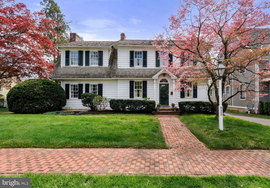Situated on a large lot in the charming Borough of Newtown sits this quaint Colonial. With its origins dating back to 1923, this home has been lovingly transformed and updated throughout its 52 years of ownership.   The main living level boats rich hardwood floors, beautiful millwork, a more formal living room, dining room with vaulted ceiling and a wall of windows, a very generously sized  eat-in kitchen with center island and plenty of storage in the timeless custom cabinets as well as a cozy family room with beamed ceiling & wood burning fireplace and library with tailor-made bookshelves. The second living level offers a primary bedroom with walk-in closet plus two double closets, a sweater closet, custom cabinets, linen closet and full bath with stall shower & jetted tub. Two additional bedrooms with double closets, a full hall bath and a small flex space round out the second floor. A large brick patio off the rear of the home offers a wonderful place to enjoy your morning coffee, dine al-fresco or simply gather to enjoy the outdoors. The open and level yard is enclosed in front by a charming picket fence, and in the rear by a privacy fencing. Enjoy swimming in the in-ground pool at the rear of the yard – also surrounded by brick patios. Walk to town. Convenient to shopping and dining with easy access to I-95.  Award winning Council Rock School District.  Agent Elizabeth Danese has an ownership interest in this property and related to the co-owner owner.