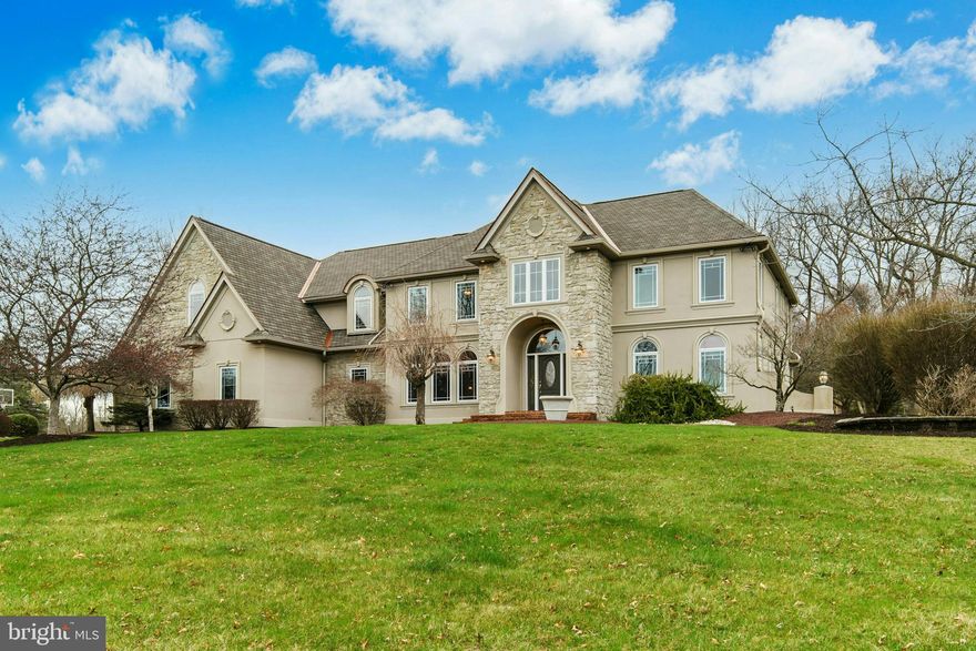 Upon entering Southmoore Manor, it is not surprising that upgrades and finishes abound as it was thoughtfully constructed by a local builder for his personal residence to showcase his high-level of craftsmanship and design. Luxuriously curated and elegantly presented with heated floors, beautiful millwork, archways, new paint, new carpets and designer finishes, the home’s condition is comparable
to new construction while the appointments exceed the craftsmanship available today. The heart of this home is the soaring great room with 20’ tray ceilings and a floor-to-ceiling stone fireplace and dream kitchen, boasting heated floors, granite counters, designer fixtures, high-end appliances and French doors to the patio and inground pool. A first-floor guest suite, living room with fireplace, and bulk pantry are added bonuses. The split staircase with twisted iron balusters leads to a spacious second floor. The primary bedroom is a true sanctuary, featuring a spa-like ensuite with exquisite finishes, a jetted tub, oversized shower, and massive walk-in closet. Four more notably large bedrooms with walk-in closets and a roomy and thoughtfully designed laundry room complete this level. An expansive lower level offers space for play and relaxation for all as it encompasses a recreation room, media room,
exercise room, and workshop.    The 1.3 acre cul-de-sac lot is enviable, with patios, saltwater inground pool, mature trees and upgraded landscaping.  The sought-after neighborhood has a nearby 18-hole golf course and easy access to the Lehigh Valley and points North.