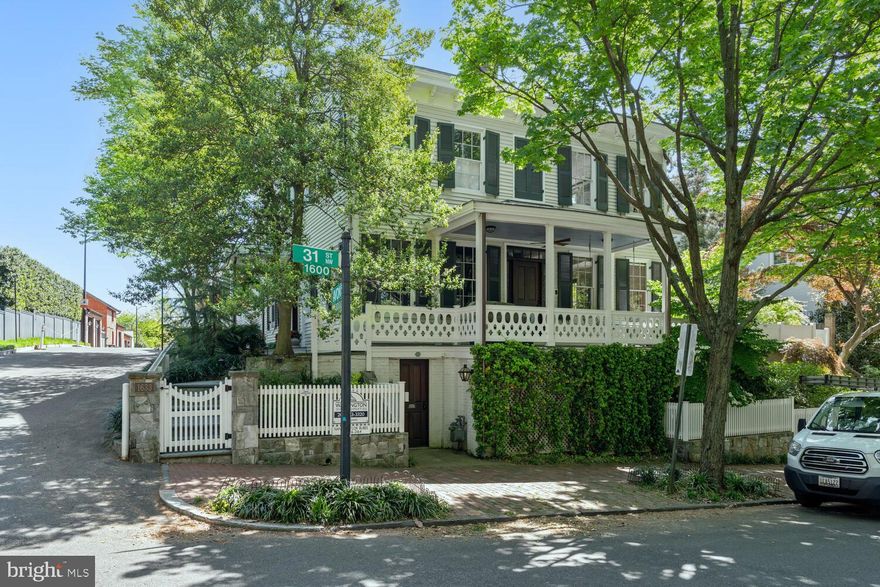 Impeccably renovated by Georgetown's esteemed Architect Christian Zapatka, 1633 31st Street NW stands as a captivating spectacle with unparalleled curb appeal situated directly across from historic Tudor Place with a 3 car Garage! The exterior radiates the charm of a Nantucket farmhouse, featuring a welcoming wrap-around porch, white picket fence, and garden. While retaining its traditional Federal facade, the interior presents a modern transformation. 

Step inside to discover a sophisticated contemporary style, adorned with remarkable moldings and finishes in every room and hallway, with no detail overlooked. Interior features include 5 custom granite / quartzite surround mantel fireplaces, walnut flooring, custom Lutron lighting with programmable custom scenes in each room, ceiling speakers throughout the house, garage and gardens controlled by HEOS. Upon entering the home, you are greeted by a beautiful, curved sweeping staircase. The Poggen-Pahl kitchen is a chef's dream, equipped with a large center island, and top-of-the-line Sub-Zero and Wolf appliances, complemented by ample storage amongst the quartzite counters and walls. The kitchen enjoys a connecting butler pantry situated between the kitchen and dining room, fit with built-in wine refrigerator and ample custom cabinets for glassware. 

The primary bedroom suite is a sanctuary with surrounding windows offering views of Tudor House and 31st Street, two walk-in custom closets, laundry, custom fireplace, and an opulent all-marble primary bath with two separate custom vanities and separate water closet. Complete with a gated custom-landscaped lighted backyard with fountain and hardscape patios perfect for entertaining, the home also offers ample ease of city living with its private 3-Car Garage ideally situated off Avon Lane. This exquisite residence is truly a one-of-a-kind offering in Georgetown's sought after East Village.