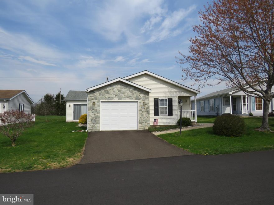 Welcome to this charming Lahaska model located in a desirable active 55+ community! Perfectly positioned to back to open space, this home offers both privacy and scenic views.
Step onto the covered front porch and enter into a welcoming foyer with a convenient coat closet. The bright and airy living room flows seamlessly into the dining room, creating an ideal space for entertaining. The spacious kitchen features an island, eat-in area, and direct access to the garage—making grocery trips a breeze.
Just off the kitchen, you’ll find a lovely sunroom filled with natural light, complete with sliding glass doors that lead to the back deck—perfect for enjoying peaceful outdoor views. The sunroom also offers access to both the front and back yards.
Down the hall, a full bathroom with new flooring and a laundry room with exterior access add everyday convenience. The second bedroom is ideal for guests or a home office, while the primary suite is tucked privately at the end of the hall. The primary bedroom features a full wall closet and a spacious en-suite bathroom with new flooring, a soaking tub, separate shower stall, and a large vanity.
This home is priced to allow you to add your personal touches and make it truly your own. Don’t miss this opportunity to enjoy comfort, convenience, and community living!