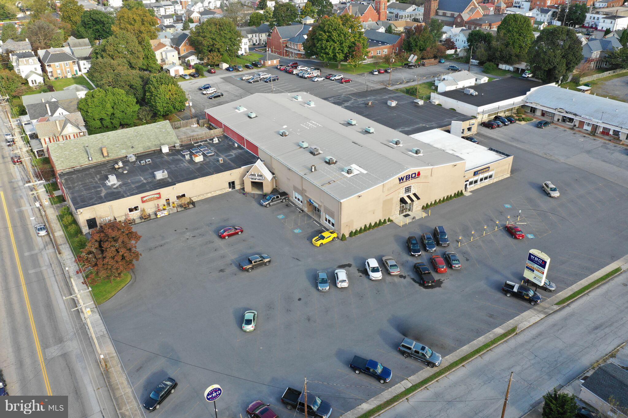 Great opportunity to own income-generating, leased, mixed-use center. Package of properties includes Commercial spaces currently leased to well-established tenants on Walnut St, and loft/residence at 29 E Third St. Ample parking included, see attached documents for aerial.