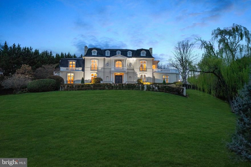 Extraordinary Value for an Iconic McLean Estate
French Château Elegance on 5 Private Acres with Resort-Style Grounds
Welcome to a masterpiece of timeless grandeur and refined luxury, nestled on five majestic acres in the heart of McLean. Inspired by the châteaux of the Loire Valley, this one-of-a-kind estate is a true architectural jewel offering unrivaled privacy, scale, and craftsmanship.

From the moment you approach the stately gated motor court, the residence makes a commanding impression. A classic mansard roof, Juliet balconies with wrought iron railings, and expansive rooftop terraces evoke a sense of regal sophistication. Double doors open into a breathtaking two-story foyer, crowned by 20-foot ceilings, travertine floors, and gilded crown moldings that set the tone for this exquisite home.

Grand Interiors Designed to Impress
Sweeping marble staircase with gold-leaf wrought iron and brass railings, an unforgettable centerpiece
Private executive office with floor-to-ceiling mahogany built-ins and a gas fireplace
Formal dining room with custom china cabinetry and elegant fireplace, ideal for lavish entertaining
Formal living room with triple-arched French doors, ornamental plasterwork, and a grand fireplace
Full-service bar in cherry, walnut, and leaded glass connecting to a magnificent great room with soaring ceilings

Gourmet Kitchen & Casual Living
Chef-inspired kitchen with dual oversized islands, granite countertops, and premium cabinetry
Breakfast room opening to a cozy family room with a stunning stone fireplace
Butler���s pantry, elegant powder room, and oversized laundry room provide practical luxury

Private Quarters of Distinction
Primary suite is a true sanctuary with private balconies, fireplace, dual walk-in closets with granite tops, and a spa-style bath featuring Jerusalem Gold limestone, jetted tub, and steam shower.

Four additional ensuite bedrooms with refined finishes, crown molding, and walk-in closets
Expansive rooftop terrace off the grand hall with panoramic views of the estate

Entertainment & Wellness Retreat
Walk-out lower level with full bar, rec room, game room, gym, and sixth bedroom suite
Bonus rooms include a cedar closet, staff/maids quarters, and abundant storage
Four-car garage with EV charger, climate control, and custom cabinetry
World Class Outdoor Living
50’ x 25’ heated pool with retractable electronic cover
Glass stone firepit, cascading waterfall pond, and multiple stone terraces
Lush, mature landscaping with ambient lighting, tiered gardens, and intimate garden pathways
Private courtyard patio with lattice privacy panels and gated access to pool and service drive

Modern Comfort Meets Classic Opulence
Whole-house generator
Newer seven-zone HVAC system
Smart home upgrades and security throughout

Why This Estate Stands Apart
This is more than a home, it's a statement of success and legacy. A property of this caliber, combining European charm with modern amenities, rarely becomes available in McLean. This extraordinary offering is not only captivating, it’s an incredible value.

Private showings by appointment only. Experience the grandeur, the serenity, and the luxury lifestyle you deserve.