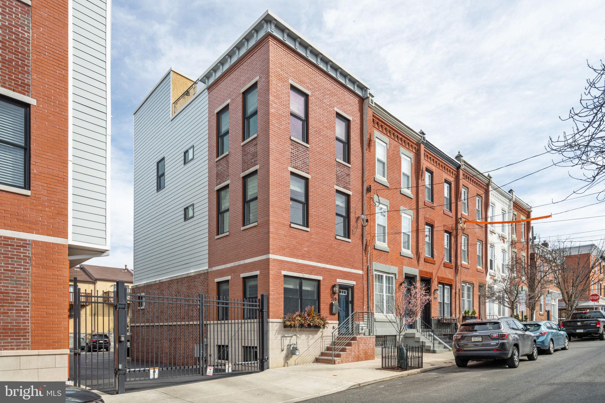 Come and tour this beautiful, CORNER UNIT home with gated parking centrally located in the Fairmount/Art Museum Neighborhood. This house is two blocks from all of the shops, restaurants and coffee houses on Fairmount Avenue and a few blocks from Kelly Dr, Boathouse Row, and the Art Museum. The 1st floor with 10' ceilings has an open floor plan with a spacious living room, dining area and a gorgeous kitchen with marble countertops, marble backsplash in a herringbone pattern, custom cabinets, a center island, walk-in pantry and stainless steel appliances including a Thermador 6-burner range and hood vent. The 1st floor is completed with a powder room and sliding glass doors that lead out to the back deck and parking space. The 2nd floor features two spacious bedrooms and a full bathroom with heated floors, a tub and a double sink vanity. The 2nd floor also has an ideally situated laundry room with cabinetry and a separate mechanical room. The top floor features the primary suite. This suite feels like a private retreat with a large bedroom with 4 windows beaming with natural sunlight, sitting area, a generous walk-in closet with custom shelving and a spa-like bathroom. The bathroom with heated floors and marble tile has a walk-in shower, a double sink vanity and water closet. The roof deck equipped with a wet bar is extremely private and offers amazing 360 degree views including the city skyline! The roof deck and deck off of the kitchen are both perfect for outdoor entertaining. The lower level with a 2nd powder room and custom, built-in shelves adds additional sq ft and can be used as a home office, media room and/or home gym. No expense has been spared from the limestone and red brick exterior to every interior finish. This house truly stands alone! There’s more: @4 years remaining on the tax abatement, hardwood floors throughout, motorized blinds, custom closets, Andersen window, lots of storage space, wireless security system and dual zone HVAC. Walk score of 90 and a bike score of 94! **2615 Brown St comes with one designated parking space directly behind the house. The owner currently rents a 2nd parking space at a garage down the street and can transfer the parking to the new owner for $275/month.** The total sq ft including the finished basement is around 2635 sq ft.