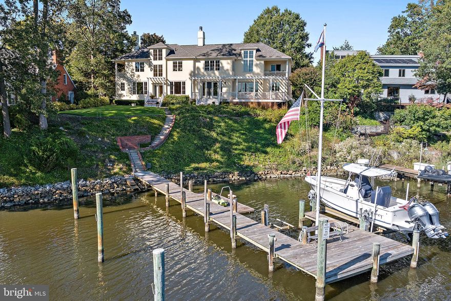 Custom built and beautifully sited on Spa Creek, this waterfront residence offers over 5,000 square feet of above-ground living space with 6–8’ MLW, private pier with 10,000 lb boat lift and sweeping water views of Spa Creek. A gracious front hallway entrance with a curved staircase sets the tone for the home’s elegant design and inviting flow. The main level features hardwood floors, recessed lighting, and water views from nearly every room. The living room includes built-in bookcases and a wood-burning fireplace, while the family room—located off the kitchen—offers a second wood-burning fireplace and access to the expansive IPE deck with pergola. The dining room overlooks Spa Creek, and the custom kitchen features white cabinetry, refinished granite countertops, Thermador appliances, and a large island with gas cooktop.
Upstairs, the spacious primary suite includes cathedral ceilings, a gas fireplace, soaking tub, walk-in closet, and an adjoining office/flex space with private waterfront balcony. Additional highlights include a guest suite with balcony, third-floor studio/office, and separate in-law or nanny quarters with full bath, kitchenette, and private entrance. A large mudroom with multiple closets, laundry area, and half bath connects to the oversized two-car garage.
Recent upgrades include an architectural-grade roof (2023), resurfaced Dryvit exterior (2023), two new hot water heaters (2025), encapsulated crawl spaces (2025), new smoke detectors (2025), and a whole-house generator. Exceptional waterfront living just minutes from downtown Annapolis.