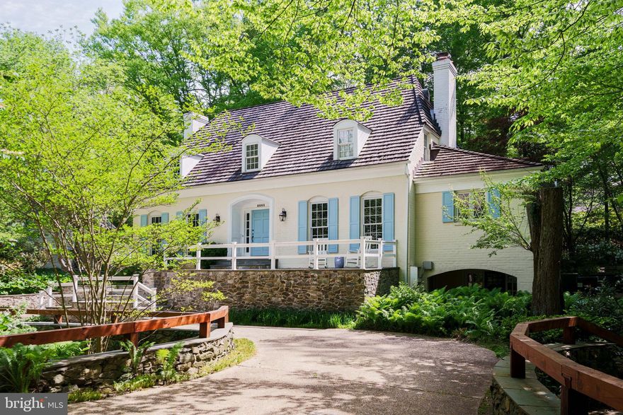 Step into your own piece of Bethesda charm nestled in the heart of the exclusive Bradley Hills Grove, one of Bethesda's most coveted neighborhoods.

This enchanting English-style cottage, nestled on a tranquil cul-de-sac, offers a secluded oasis mere minutes from DC.

Cross the circular driveway, doubling as your private bridge over a serene "moat," and step into a bright, expansive living room with floor-to-ceiling windows complemented by a sunroom that offers breathtaking views of the lush grounds.

Discover the secret office hidden behind a bookshelf door, blending modern elegance with classic charm, complete with its own fireplace and built-in bookshelves.

Entertain in style with a gourmet kitchen and ample patio space, perfect for al fresco gatherings. The above-ground basement boasts a luxurious guest suite with a walk-out Spanish-style patio, offering a serene retreat by the gazebo overlooking the tranquil creek and foliage.

Crafted by the esteemed Tom Rixey, this home is a masterpiece of timeless craftsmanship and attention to detail. With four fireplaces, numerous skylights, a primary suite with vaulted ceilings and an extra large tub, french doors throughout, a sauna, and a massive laundry and mud room this home features far too many original and upgraded amenities to list.

Don't miss this rare opportunity to own a piece of Bethesda's architectural legacy.