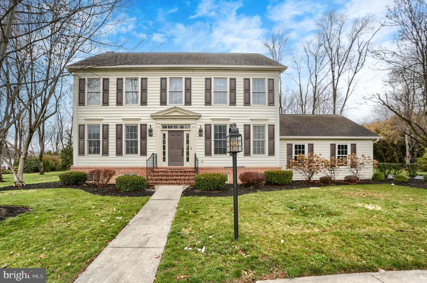 Experience the best of classic design and modern living in this Williamsburg style Colonial, ideally located in the sought‑after Village of Westover (East) in Hampden Township, within the Cumberland Valley School District. Set on a quiet cul‑de‑sac, this home offers a tree‑lined, private 0.48‑acre lot that instantly feels like a retreat.
Inside, the layout flows effortlessly for today’s lifestyle while preserving the home’s timeless charm. Hardwood floors span the main level, leading to a beautifully updated kitchen featuring a large center island, stainless steel energy‑efficient appliances, custom cherry cabinetry, and multiple casement windows that frame serene backyard views. Three full‑size pantries and thoughtful storage elevate both style and function.
French doors off the breakfast area open to a fresh and inviting screened porch with shiplap siding, cedar posts, and custom lighting—perfect for morning coffee or summer evenings. The adjacent family room is warm and relaxed, offering coffered ceilings, windows on three sides, and a brick wood‑burning fireplace, enhanced by recessed lighting, custom wood blinds, and built‑in surround sound.
Host gatherings in the refined dining room, complete with chair rail molding, oversized crown trim, ambient lighting, and a modern oil‑rubbed bronze chandelier.
Upstairs, four generous bedrooms fill with natural light. The second floor also features a convenient laundry area, linen closet, and a guest bath with a double vanity. The spacious primary suite includes a walk‑in closet and a private en‑suite with double vanity, jetted soaking tub, ceramic tile flooring, and an oversized custom mirror.
Outdoor living shines with mature trees, curated landscaping, vibrant flower beds, and a curved stone patio and walkway—perfect for relaxing or entertaining.