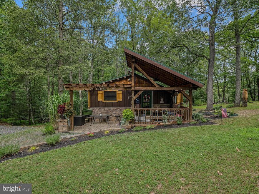 GETAWAY OR FULL TIME: don't miss this 2- bedroom 1-bathroom cabin on 2.06 acres. This cabin just feels like the perfect getaway the second you walk through the front door. It has a kitchen/dining combo, Livingroom with a woodstove, plus an electric fireplace, 2 bedrooms, an additional room that could easily become a 3rd bedroom, and laundry room. Home is equipped with a backup generator so life can go on when mother nature strikes. The outside is landscaped to catch your eye as you pull in the driveway. With the garage/outbuilding & shed you will have plenty of room to bring your toys. This subdivision offers a community lake for fishing and boating with a beach area for swimming, community pavilion and community ballfield. You can also access from within the subdivision the 22,000+ acres of Sleepy Creek Wildlife Management area for hiking or hunting. Just a five-minute drive to the well-known Wood Resorts two 18-hole Golf Courses. One is an 18-hole Championship Course & the other is an 18-hole mid-length course. Within 45 minutes of Whitetail Resort for skiing and less then 30 minutes from the Historic Town of (Bath)Berkeley Springs, WV. This cabin is within 2-hours from Baltimore, MD & Washington, DC