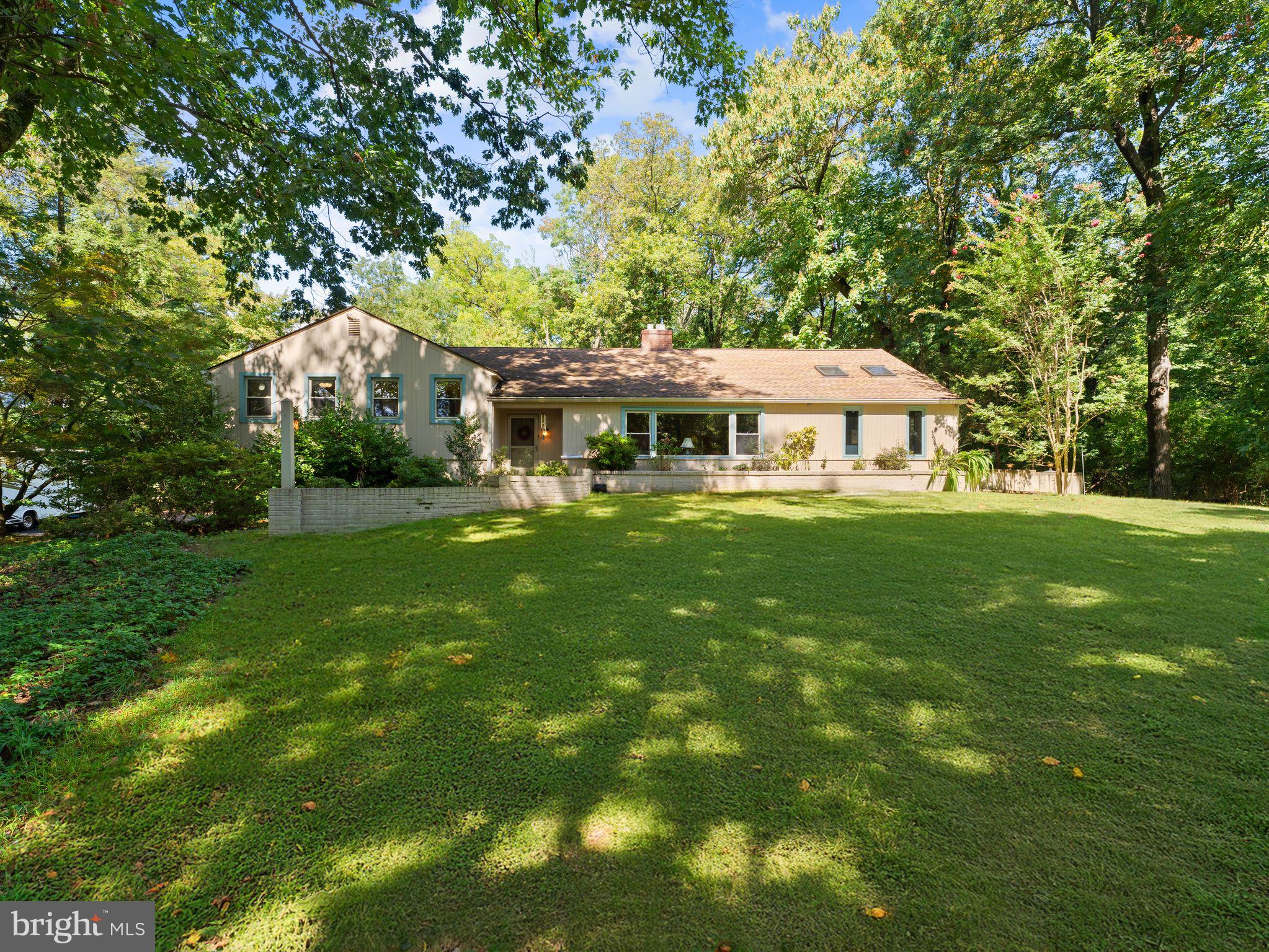 You will think you are in the woods when you approach this home. This charming home greets you with a warm foyer entrance and flows into spacious living and dining areas with newer hardwood floors. The inviting living room features a fireplace, perfect for gatherings, while the sunroom—with its skylights, separate heat/AC unit, and breathtaking views—offers a serene backdrop of the yard, garden, and frequent visits from deer and other wildlife. The family room is a showstopper, boasting cathedral ceilings accented with rustic wood beams. A private library, complete with hardwood floors and built-in bookcases, provides a quiet space for work or reading, and opens to a large patio ideal for entertaining. The unique hot tub room overlooks the yard, creating a spa-like retreat in your own home. The updated kitchen is designed for both style and function, featuring quartz countertops, ample cabinetry, a built-in microwave, stainless steel appliances—including a gas range and refrigerator—and a modern layout that makes cooking a joy. An added convenience is the electric car charging unit, making this home as practical as it is beautiful. This Elkins Park gem combines comfort, character, and natural beauty in one remarkable property. It is certainly one of kind with the wooden lot and you will never believe you are minutes from civilization.