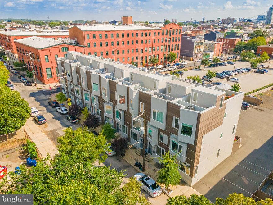 Welcome to this newer construction townhome in the heart of Old Kensington. On a quiet residential street with private parking, enter this corner, light flooded property that is complete with all the modern upgrades you'd expect of new construction. With wide plank hardwood floors throughout, this home offers two outdoor spaces, 4 bedrooms and 2.5 bathrooms. Your wide living space offers a half bath and an extra long island leads you to the fenced in back patio that allows entrance to your parking space. On the second floor you'll find two spacious bedrooms, a full hall bath, and plenty of storage space. On the owner suite level, you have a private master bedroom, en suite, and his and her's closets. Don't miss the added 4th bedroom, which brings incredible functionality to the space. Head up to the roofdeck to take in the bridge views, or take a 1-2 block stroll to the heart of Fishtown and Frankford Avenue. Walk to City Fitness, La Colombe, WM Mulherins & Sons and so much more. Electrical and venting are all in place for basement to be easily finished with just drywall! 5 years left on the tax abatement!