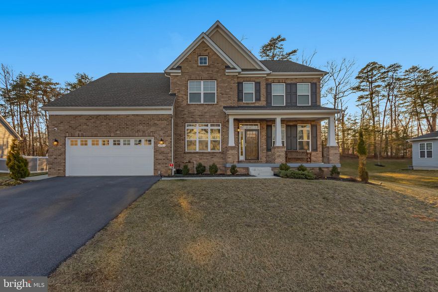 Welcome to this magnificent  gem that boasts 7 spacious bedrooms and 5.5 bathrooms, spanning over an impressive 6,300 square feet. Built just four years ago, this residence combines modern luxury with functional living. You’ll discover an in-law suite on the main level that features its own separate entrance and dedicated laundry area — perfect for guests & multi-generational living for families looking to stay close while having personal space. The upstairs master suite offers a generous walk-in closet, ensuring plenty of space for your wardrobe and relaxation after a long day. The gourmet kitchen is a chef's dream, equipped with high-end quartz countertops and a large island that comfortably accommodates multiple chairs for dining and socializing. A separate butler's pantry enhances storage and functionality, making entertaining a breeze. The main level showcases luxury vinyl plank flooring that seamlessly extends throughout the dining room, living room, kitchen, and family room, providing an elegant touch, while plush carpet covers the bedrooms and basement for added comfort. Each bedroom is designed with an attached bathroom for convenience, and all upstairs bathrooms, including the in-law suite, are outfitted with double sinks, making morning routines effortless. The den/ office features a built-in desk, ideal for a home office setup, and a rough-in is available for a full wet bar, offering additional potential for customization.
The basement is an entertainer's paradise, highlighted by a media room that includes four flat-screen TVs, all of which convey with the sale, plus an extra refrigerator for snacks and drinks. Step outside to the stone patio that stretches across the rear of the home, featuring a large gazebo that is included with the property — perfect for outdoor gatherings or enjoying a peaceful moment in nature. You'll appreciate that the front foot sewer assessment fee has been paid in full, which is a rarity for homes of this very young age.
Backing into serene woods, this home offers a private and tranquil setting, while still being conveniently located off MD 5 - Just minutes from Branch Avenue Metro, Andrews Airforce Base, shopping, other retail, and grocery stores, and only minutes away from the National Harbor, Washington D.C., and a variety of restaurants. Moreover, Brandywine and Waldorf's shopping areas are a short 15-minute drive, providing ample options for entertainment and necessities. With ample garage storage space and a welcoming covered front porch to enjoy the street view, this home has it all — making it both a stunning and fantastic residence  in a desirable location. Don't miss your chance to call this exceptional property HOME!!!