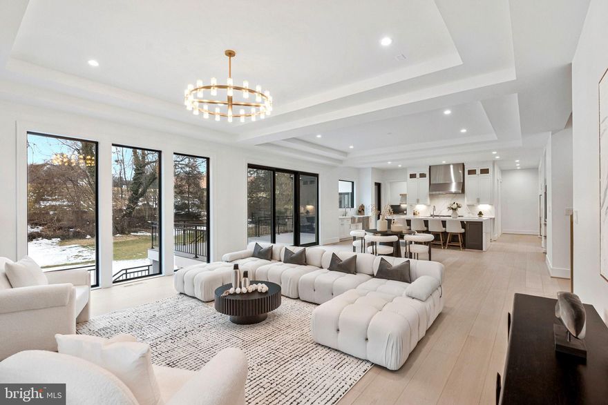 An extraordinary custom estate By KUL HOMES offering architectural distinction, refined craftsmanship, and uncompromising luxury. Thoughtfully designed with grand scale and exceptional flow, this residence is set on a private almost half acre lot backing onto lush greenery, creating a serene and exclusive retreat.
A striking open foyer makes a dramatic first impression, immediately showcasing the home’s sophisticated design and exquisite finishes. An integrated elevator shaft ensures seamless future accessibility. The expansive formal dining room is designed for unforgettable gatherings, while a private office offers an elegant and quiet workspace.
At the heart of the home lies a chef’s dream kitchen, curated with premium finishes and designed for both beauty and performance. The fully equipped spice kitchen allows for effortless entertaining and elevated culinary experiences. A main-floor bedroom paired with a full bathroom provides an ideal guest suite or multigenerational living option, offering privacy and comfort without compromise.
Every detail on this level has been meticulously considered to balance grandeur with warmth, creating spaces that feel both impressive and inviting.
The upper level is a showcase of refined comfort, featuring five generously sized bedrooms, each complete with its own luxurious ensuite bathroom. A beautifully designed loft serves as a cozy family lounge—perfect for relaxed evenings or intimate gatherings.
The owner’s suite is a statement of luxury and tranquility, offering expansive proportions and a lavish spa-inspired bathroom designed as a personal retreat. This serene space invites relaxation with a timeless, hotel-caliber ambiance.
The fully finished basement transforms the home into a complete lifestyle destination. Designed for entertainment and recreation, it features an expansive recreation room, a dedicated media room for cinematic experiences, and a private gym space for daily wellness. This level is ideal for hosting, unwinding, or creating unforgettable moments with family and friends.
Ideally situated near Tysons Corner, the home offers effortless access to major commuter routes, making daily travel seamless. Adding to its exceptional appeal, all three schools—elementary, middle, and high—are within walking distance, a rare and highly desirable convenience. This prime location delivers the perfect balance of privacy, accessibility, and everyday luxury. Some exterior photos have been edited to remove snow.